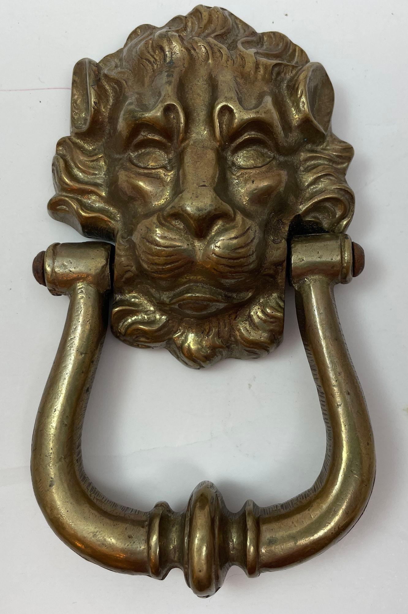 Vintage Patinated Solid Cast Brass Lion's Head Door Knocker.
Vintage large solid cast brass Lion's Head door knocker.
Georgian English style large hand cast bronze lion's head door knocker.
The lion's head form with attached knocker hand pull