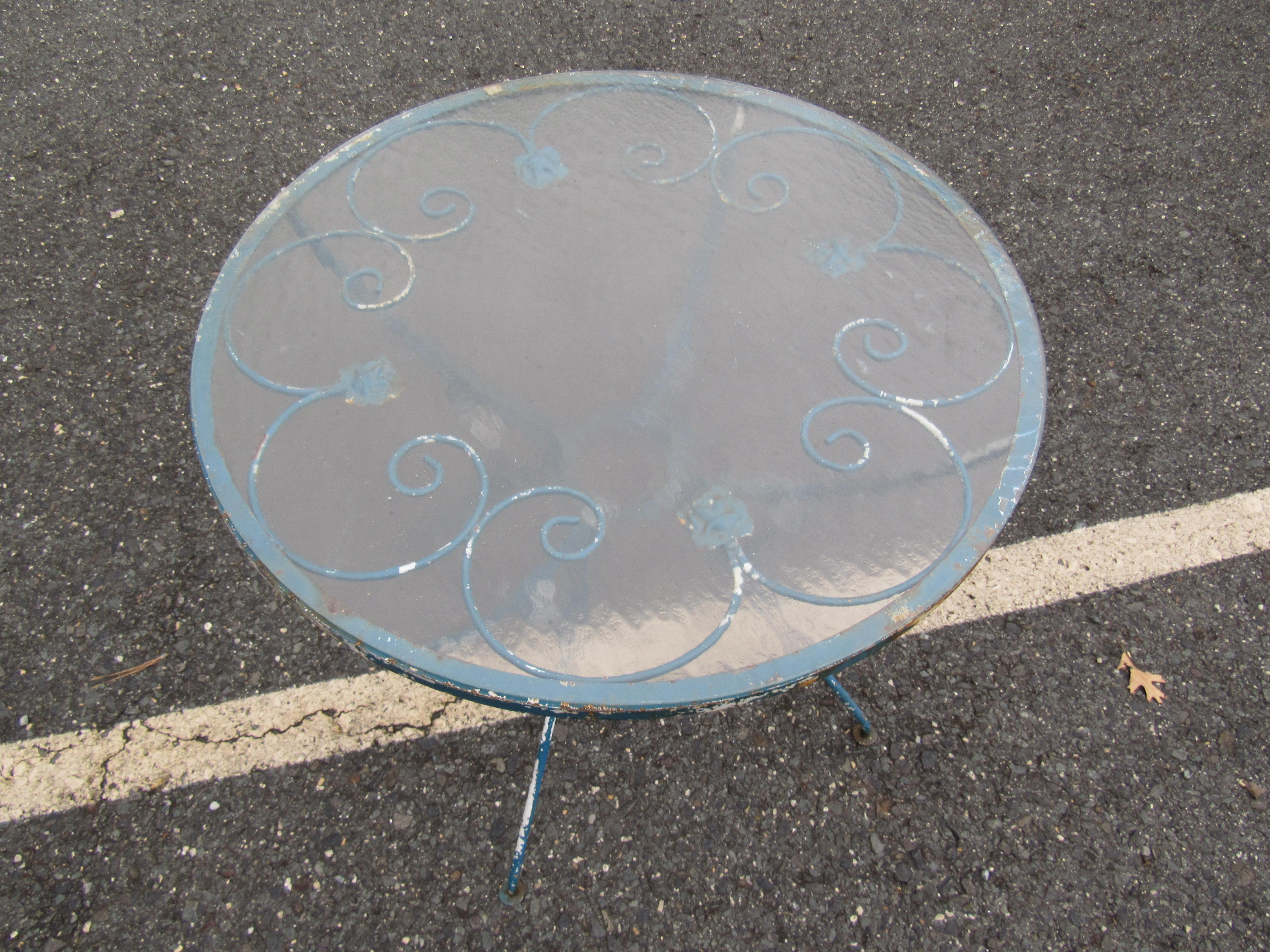 Stylish vintage patio table. Ornate accents span the base and the tabletop. Sturdy iron construction. An excellent addition to any outdoor/patio area. Please confirm item location with dealer (NJ or NY).