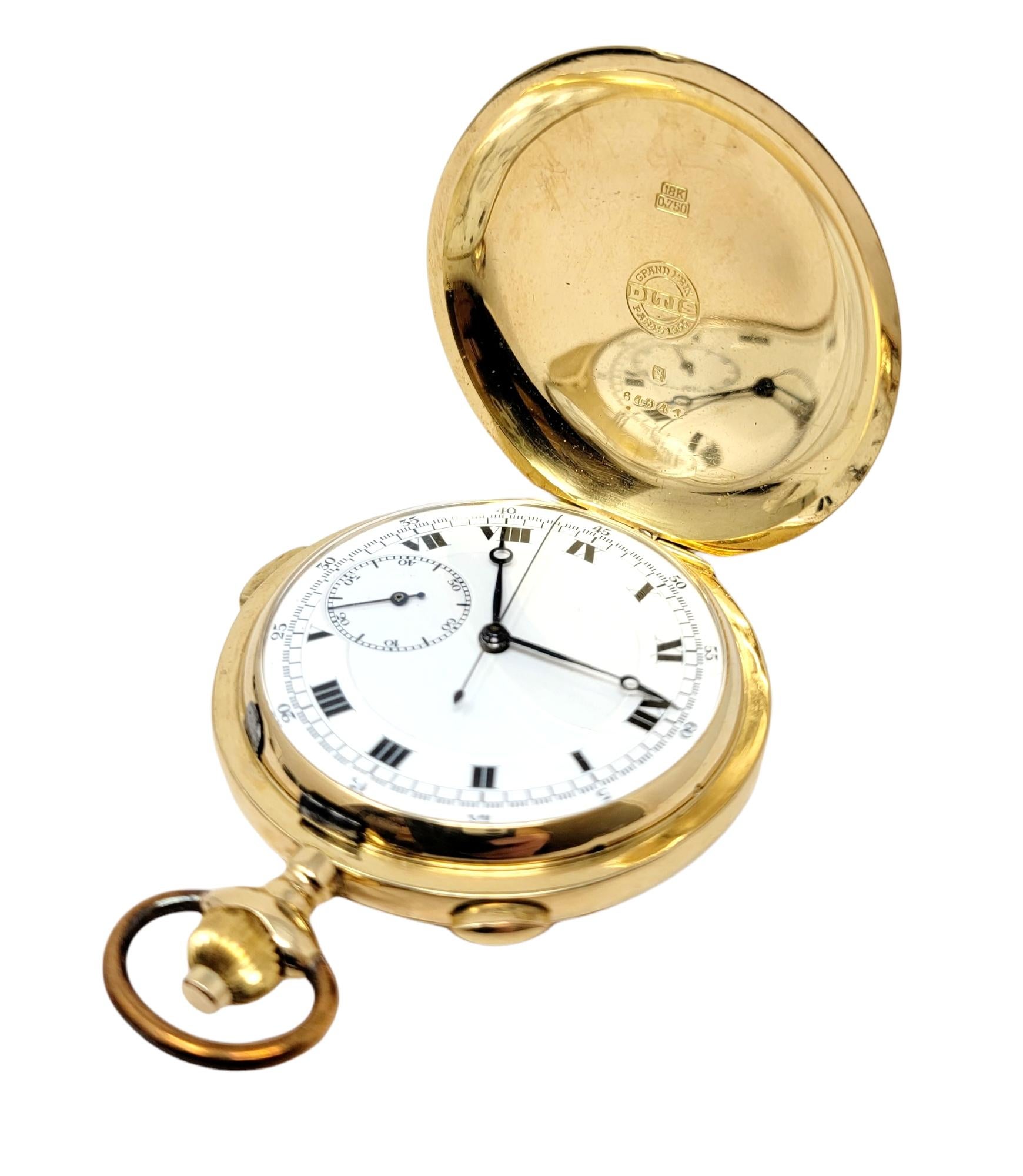 This rare vintage 18 karat yellow gold pocket watch by Paul Ditisheim is a stunning piece of history. The luxury solid gold timepiece is made with exquisite fine details. It features a 46mm case with a white face, black Roman Numeral hour markers