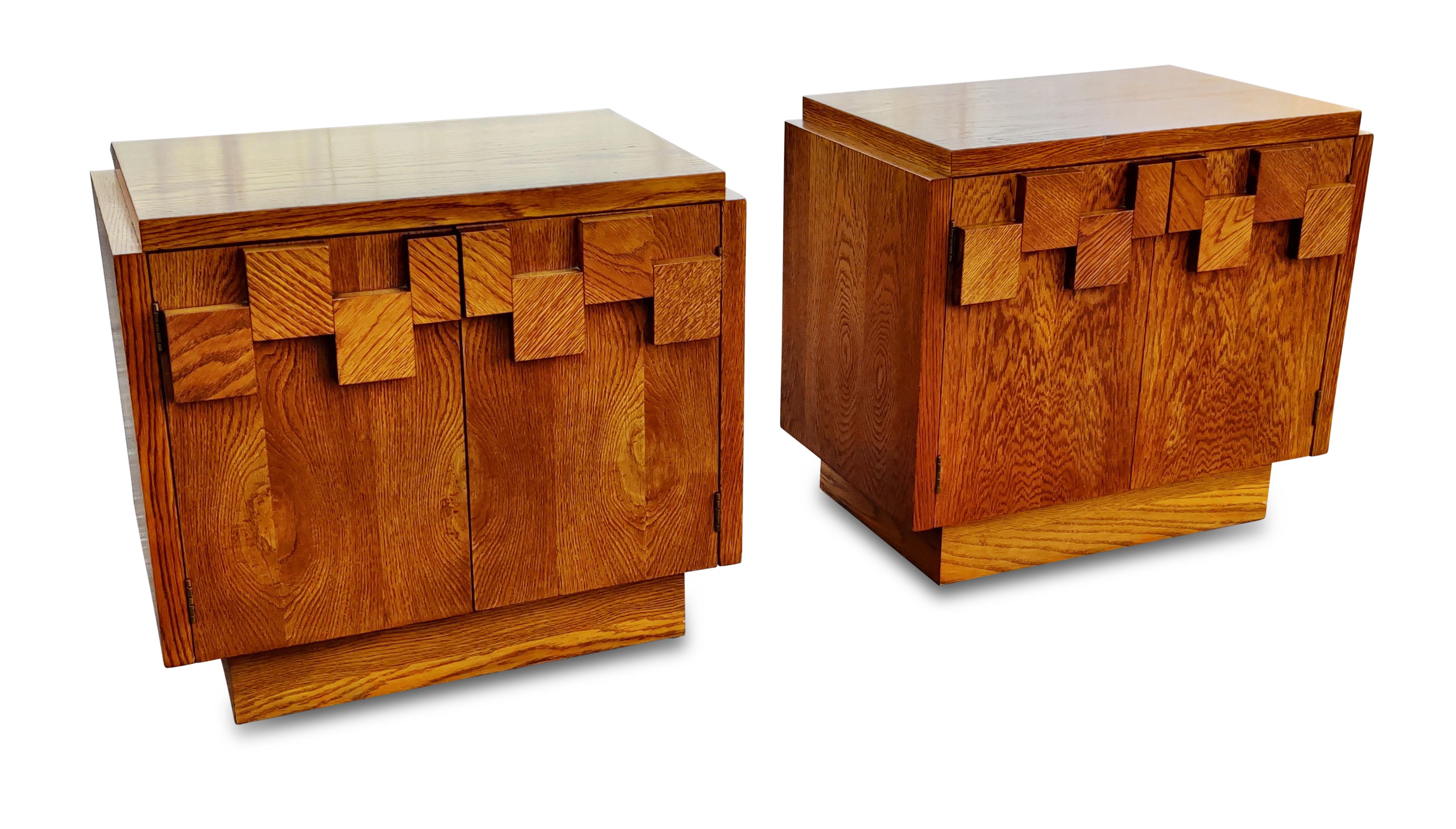 This pair of nightstands was designed in the Brutalist style made iconic by Paul Evans, and manufactured by Lane USA, circa 1970s. Made with varied blocks of oak attached to the fronts, they lend an imposing and dramatic look while retaining the