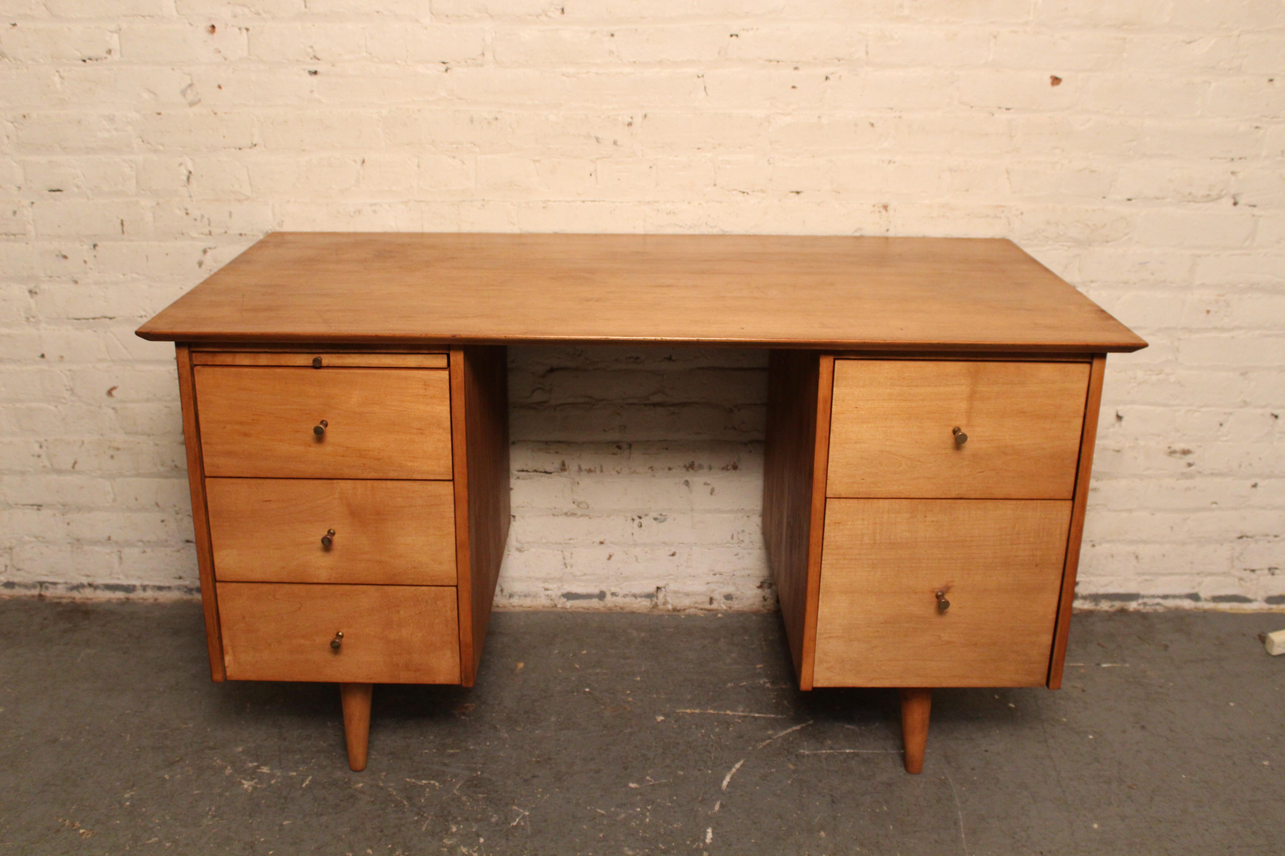 Bring home the magic of post-war New England modernism with this jaw dropping writing desk designed in 1949 by Massachusetts' native Paul McCobb for manufacture by the Winchendon Furniture Company. Made for his world-renowned 