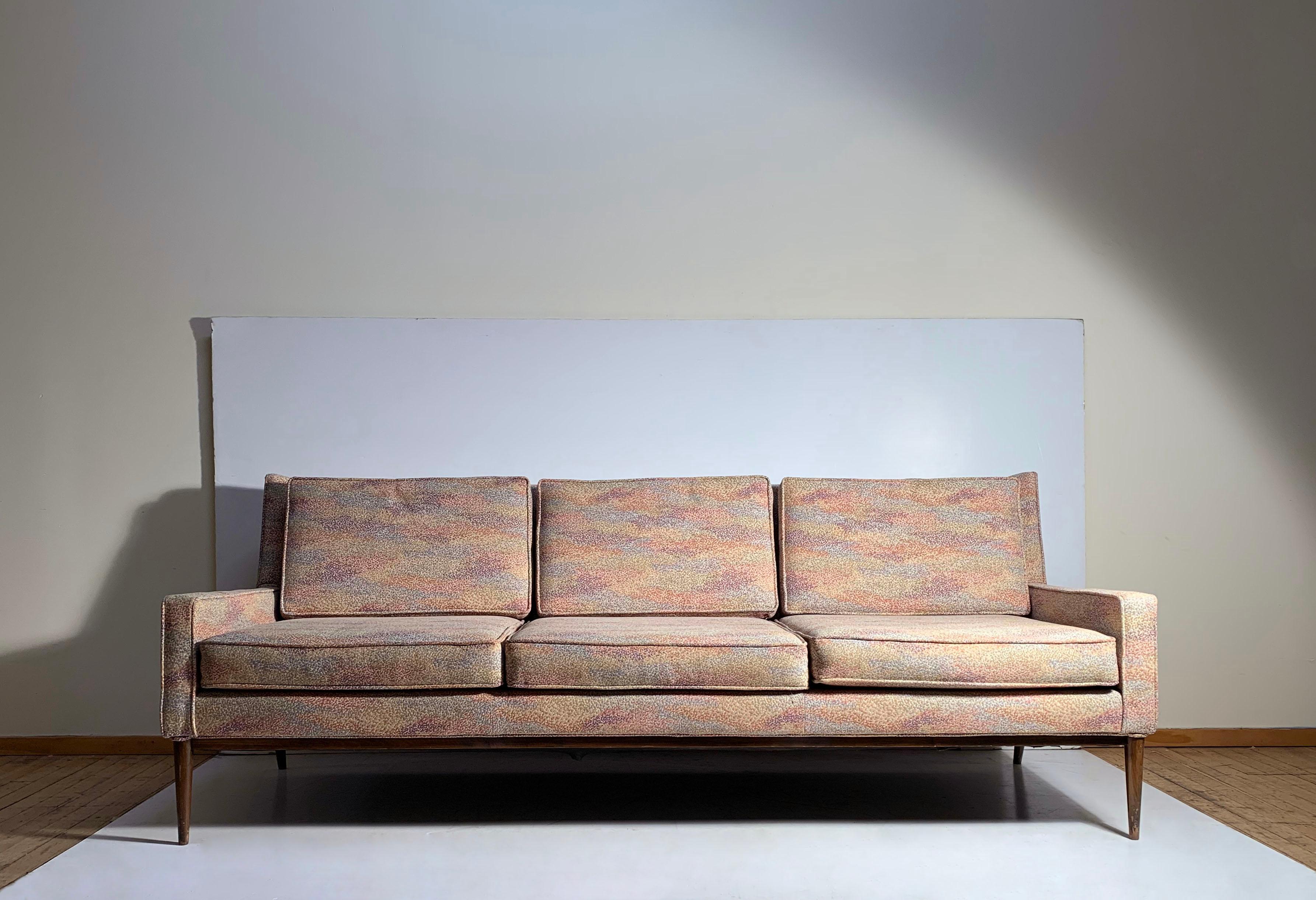 Vintage Paul McCobb sofa for Directional

reupholstered at one point. In pretty nice condition with fabric being usable as-is. minor wear. 

finish to wood and legs shows some wear.

