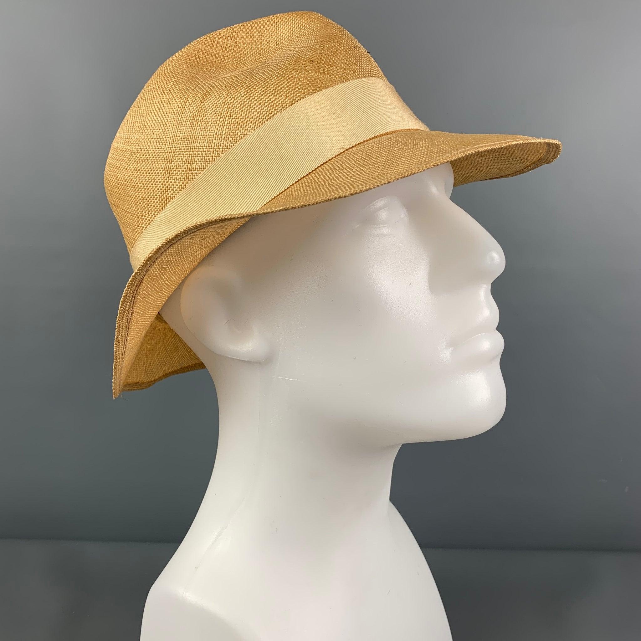 Vintage PAUL STUART hat comes in a beige straw material featuring a fedora style and a beige ribbon trim.
Very Good
Pre-Owned Condition. Fabric tag removed.  

Marked:   Size tag removed 

Measurements: 
  Opening: 22 inches  Brim: 2.75 inches 
