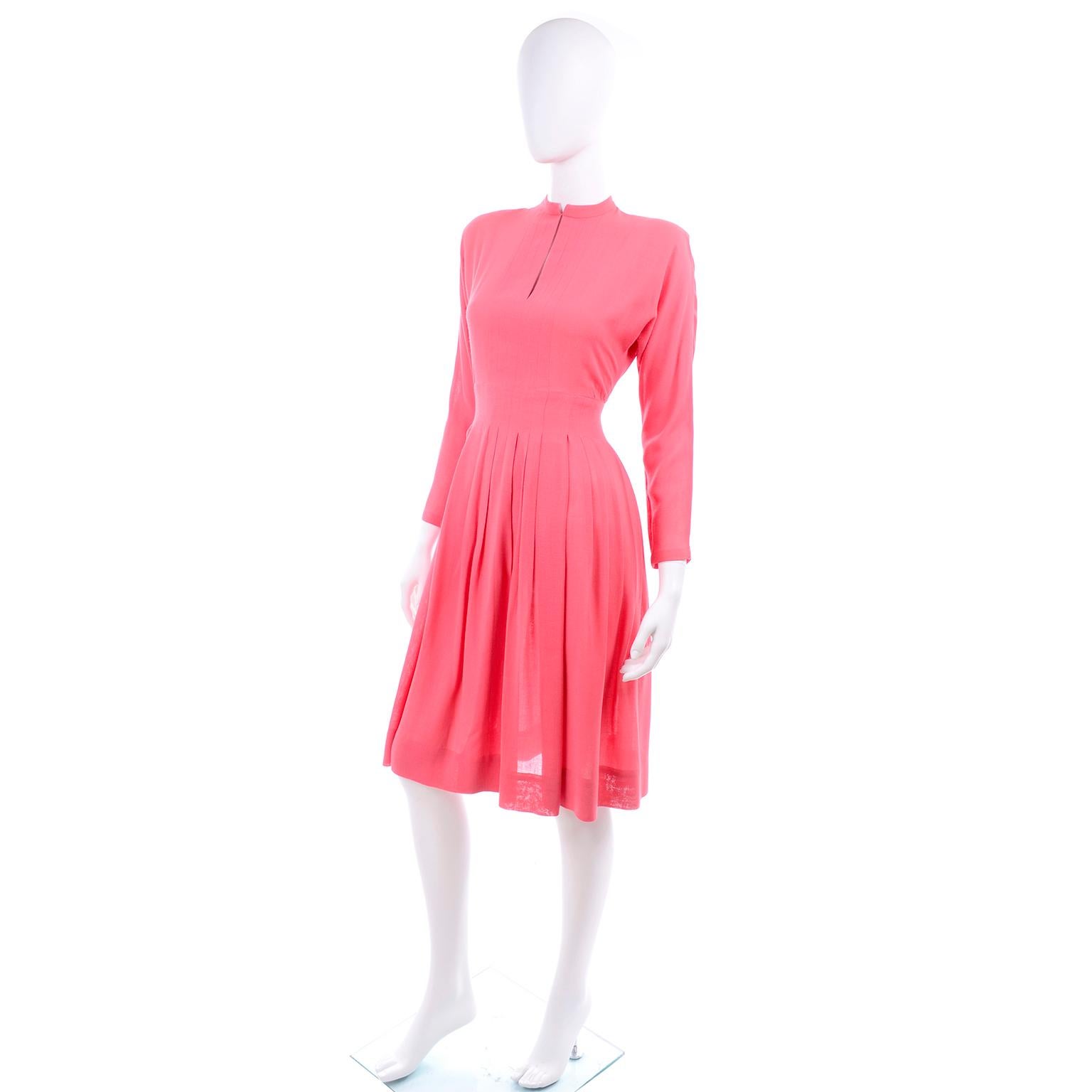 We love Pauline Trigere vintage dresses and this pretty salmon peachy pink vintage dress was purchased in the 1970's at Henry Harris of Cincinnati.  The dress has dolman sleeves, pretty pleating, a key-hole slit in the bodice and it closes with a