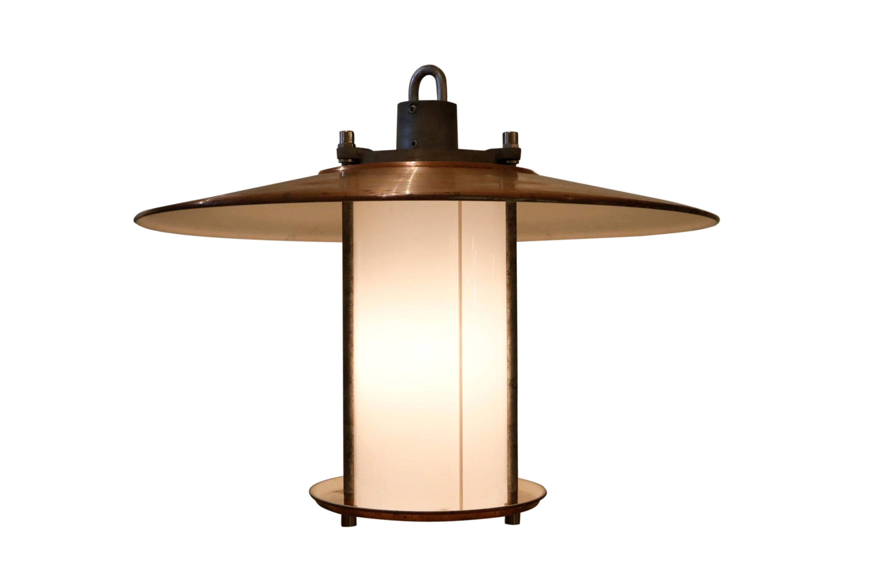 This large copper top fixture illuminates with directed down light and with ambient light, circa 1980.