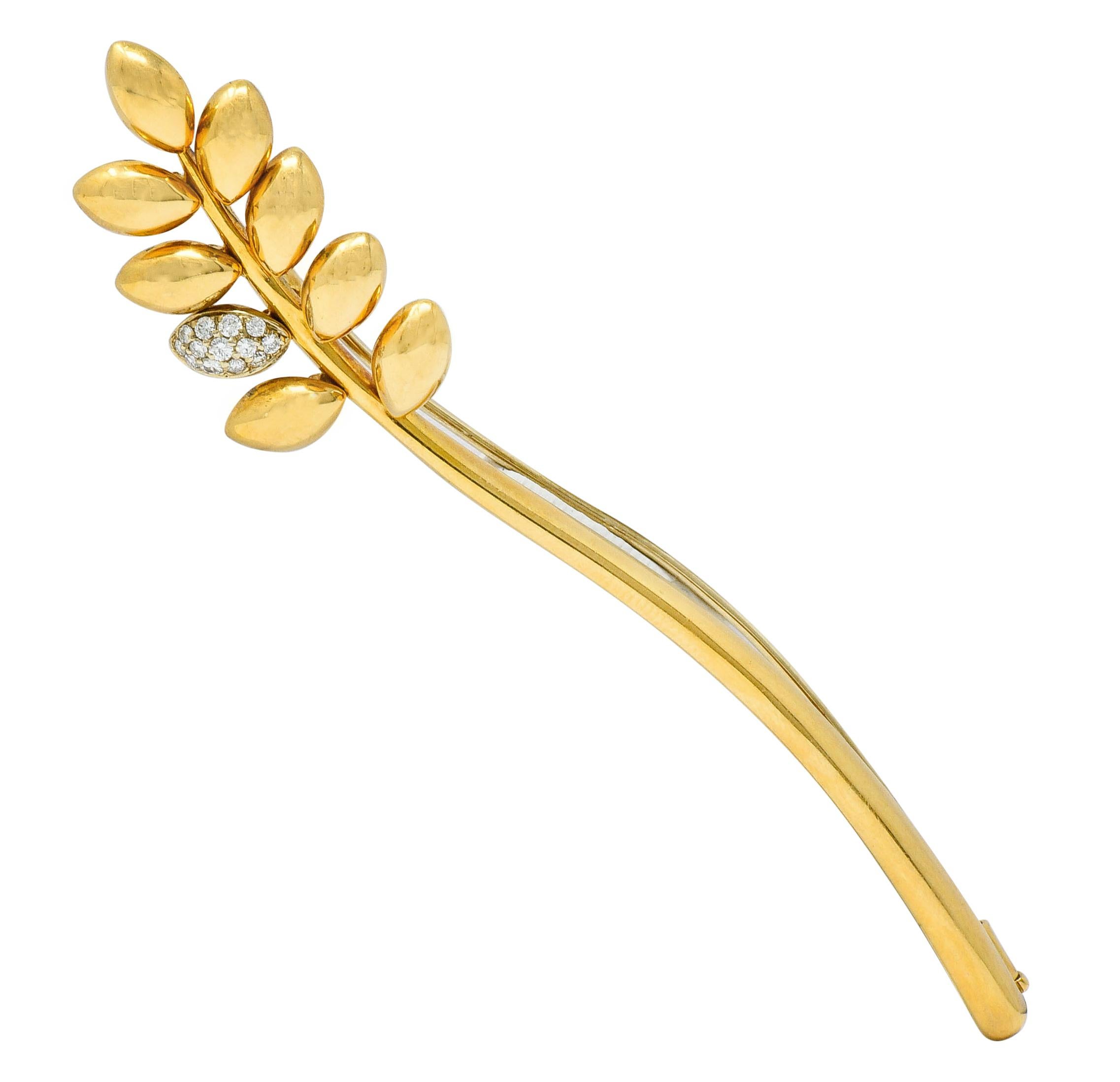 Brooch is designed as a single strand of stylized wheat

With articulation throughout polished gold grains

One grain is pavè set with round brilliant cut diamonds

Weighing in total approximately 0.20 carat; eye-clean and white

With maker's mark