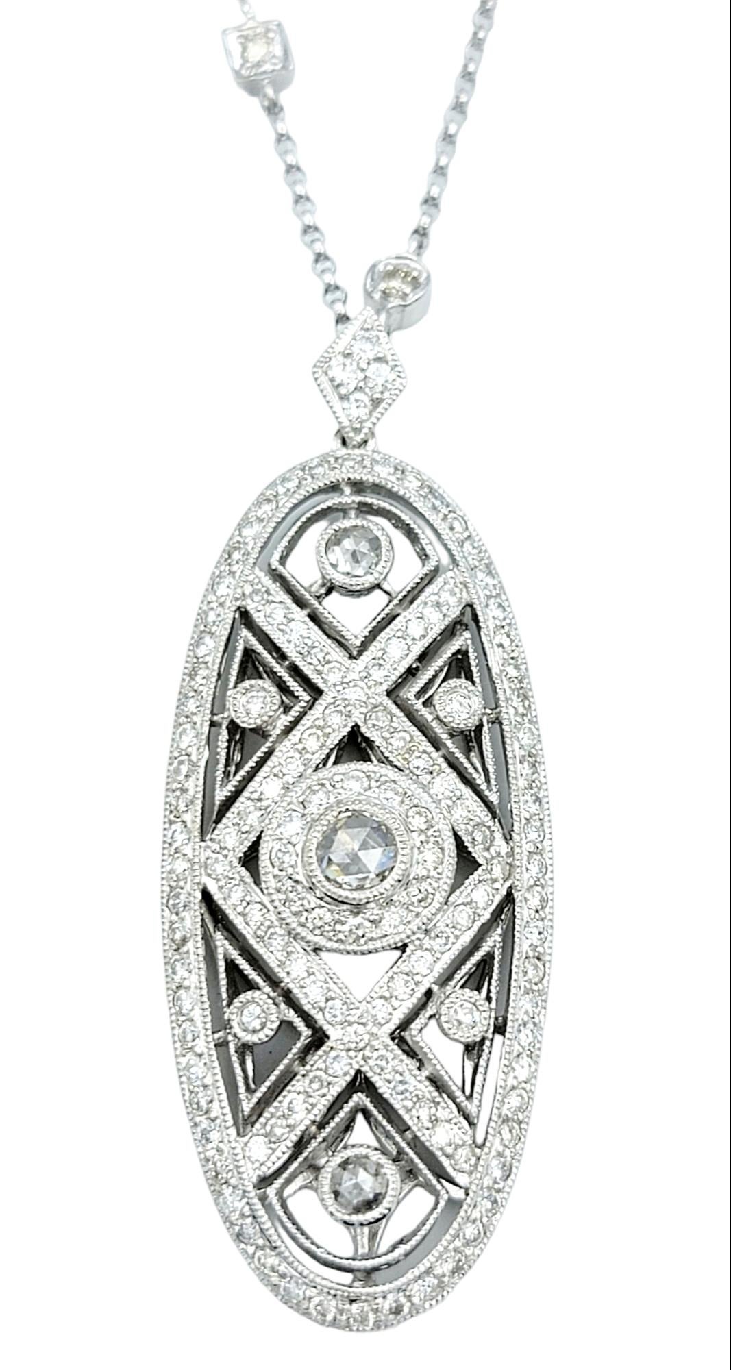 This exquisite pendant necklace is a striking example of elegance and craftsmanship. Crafted in 18 karat white gold, the elongated oval pendant features a meticulously designed cutout pattern adorned with delicate milgrain detailing, adding a