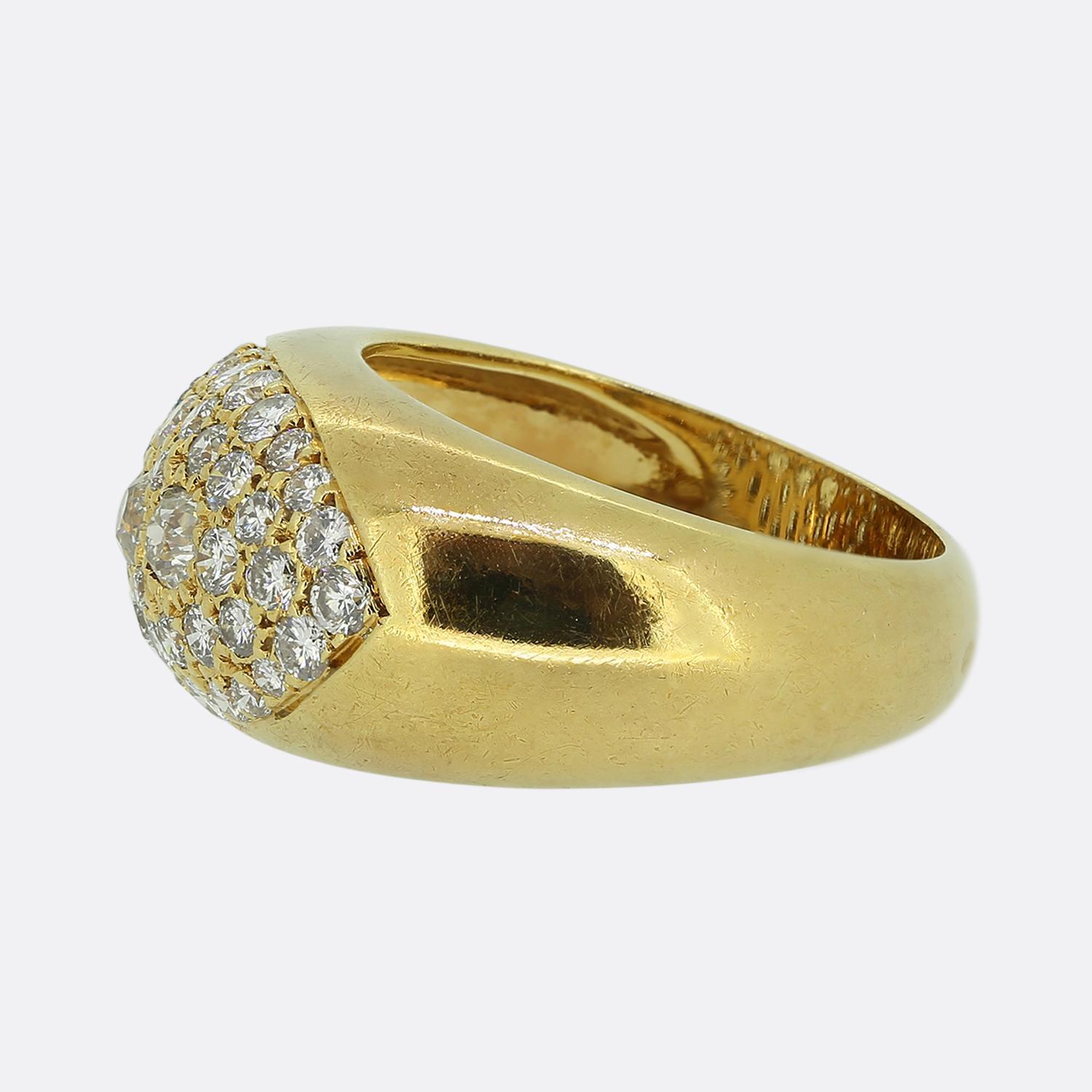 Here we have a wonderful pavé diamond set ring. This continental vintage piece was crafted in France from a rich 18ct yellow gold and features a trio of round faceted old mine cut diamonds at the centre of the face. These antique stones are then