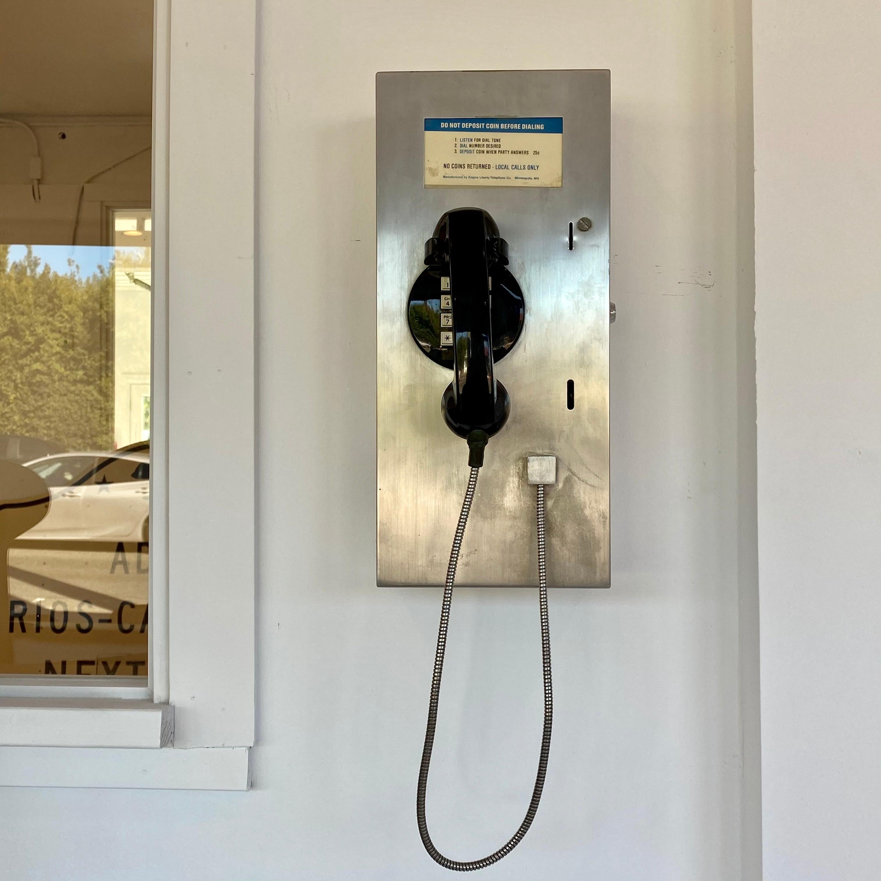 Unique vintage silver 1980s pay phone from Minneapolis, MN. Includes key that unlocks inside compartment. Great piece of wall decor or hidden stash box. Good vintage condition. Working phone!