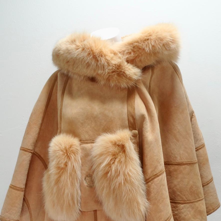 Get your hands on this incredible suede mid century poncho! Beautiful peach-toned suede comes together with the softest fur detailing to create this show-stopping poncho! The poncho is completed with an adorable fur-lined pocket at the center which