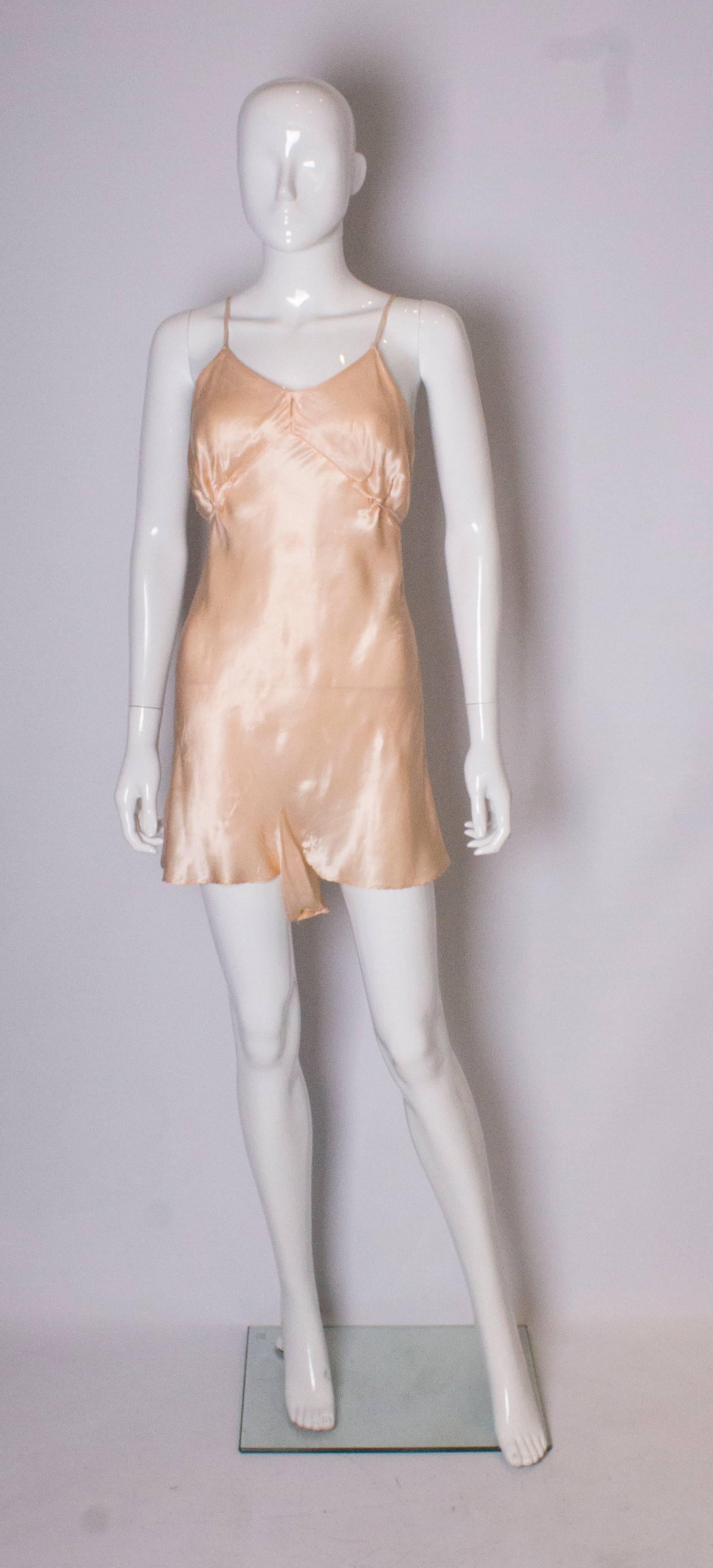 A pretty vintage peach satin cami nickers with tie detail on front and spagetti straps.