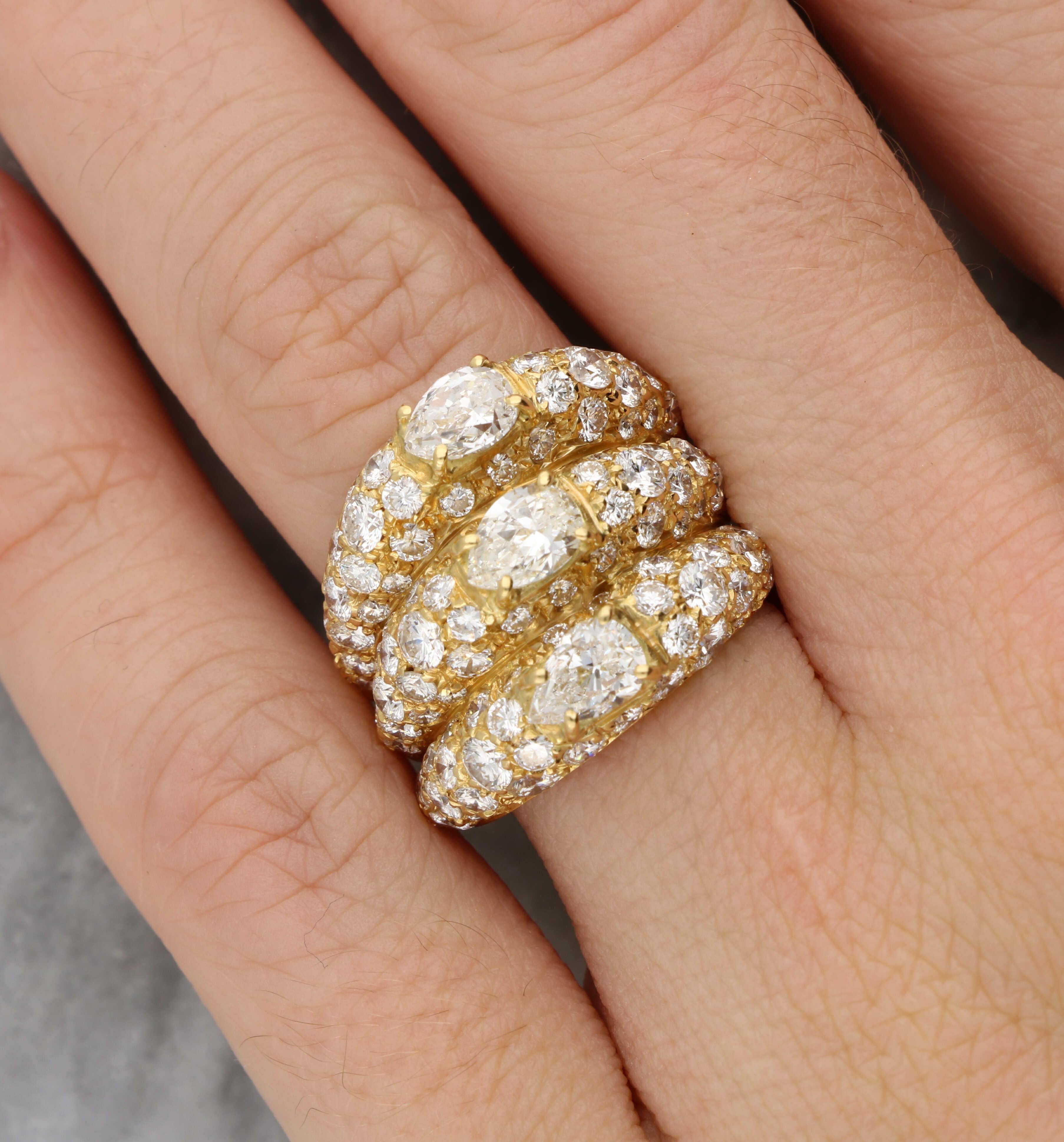 A spectacular vintage stacked diamond cocktail ring set with pear and round brilliant cut diamonds, in 18k yellow gold.

The ring features an intricate design set with a stunning combination of pear-shaped and round brilliant cut diamonds, each