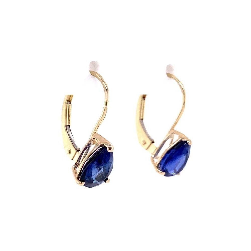 Simply Beautiful! Each drop earring is securely hand set with a Pear shape Natural Blue Sapphire. Approx. weight of 2 Sapphires is 2.38tcw. Securely Hand set with three prongs on lever back in 14K Yellow Gold. 1.25