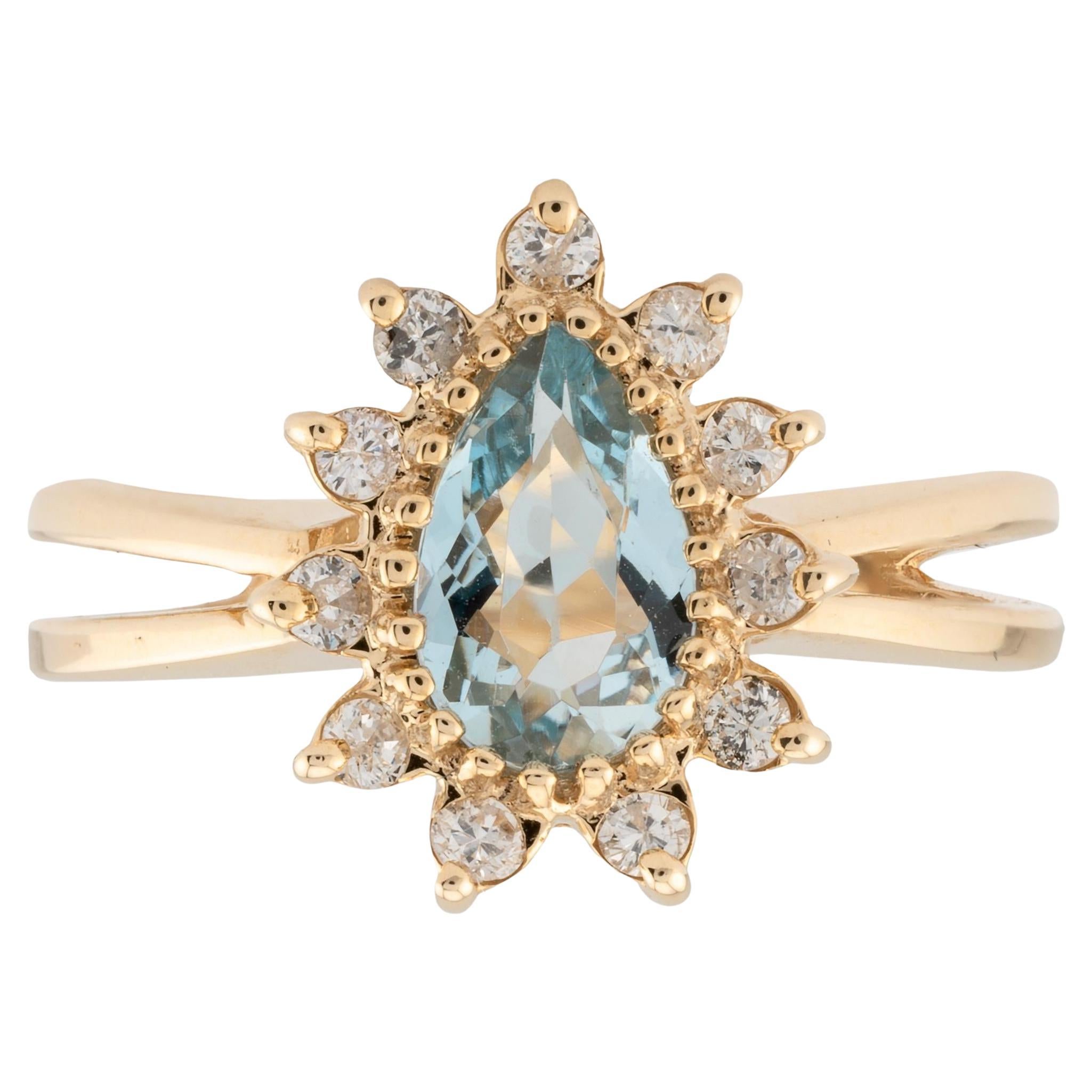 Anillo halo vintage de aguamarina en forma de pera y diamantes en oro amarillo de 14 quilates