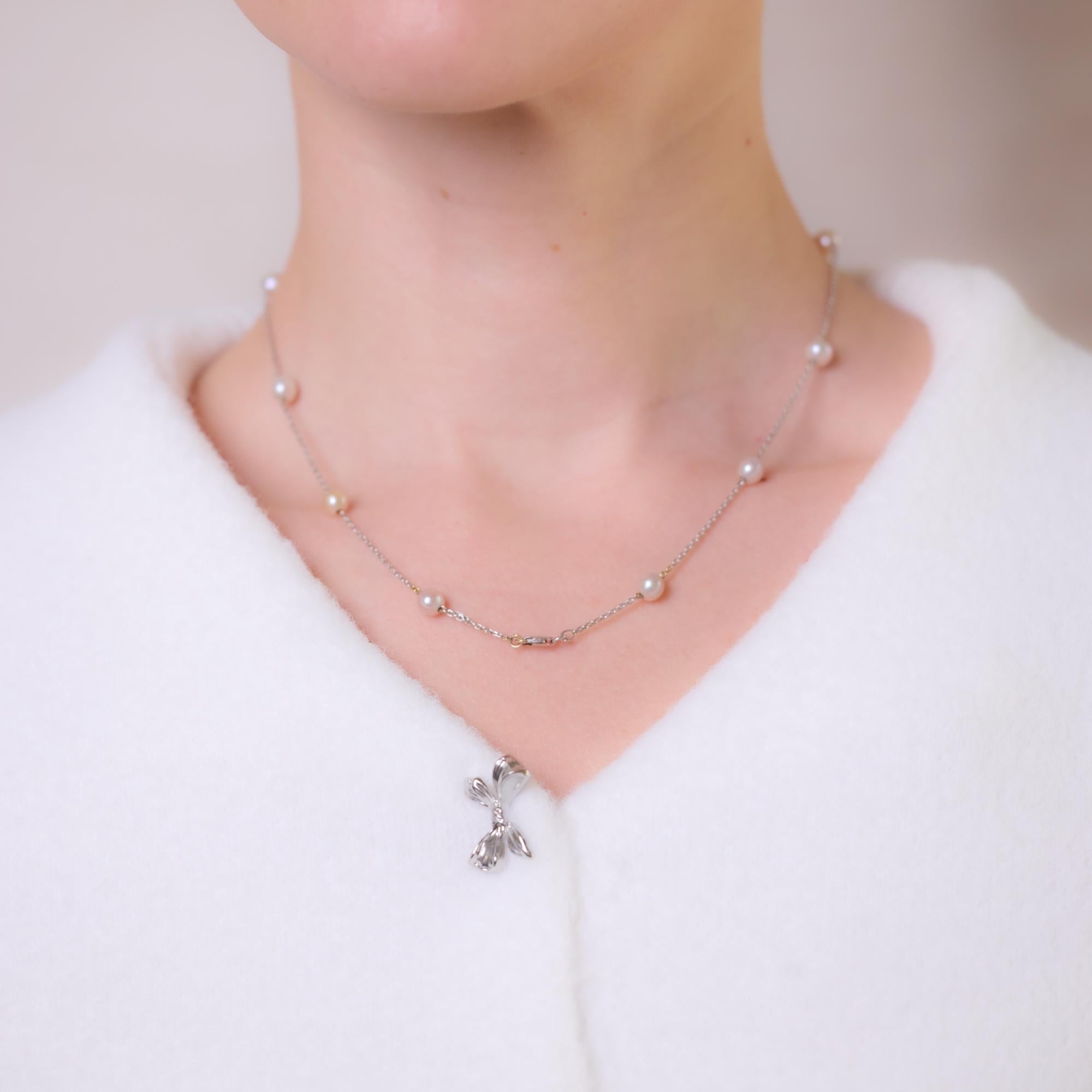 This elegant vintage 18k white gold necklace features 11 luminous pearls, each approximately 4.90mm, delicately set along a refined chain. A timeless and sophisticated design that exudes understated luxury. Hallmarked with a purity mark and maker’s