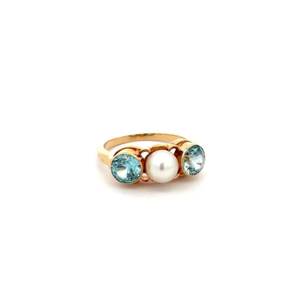 Simply Beautiful! Vintage 3-Stone Pearl and Blue Zircon Gold Band Ring. Hand set with a 5mm Pearl and Blue Zircon, weighing approx. 1.20tcw. Finely crafted 14K Yellow Gold mounting. Ring size 4, we offer ring re-sizing. The ring epitomizes vintage