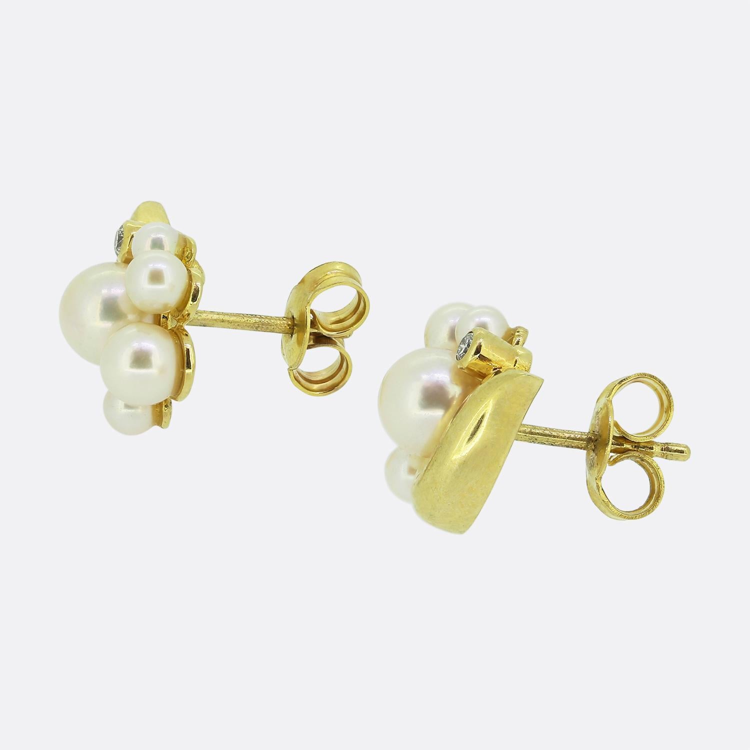 Here we have a lovely pair of cluster earrings. Each identical vintage piece has been crafted from a warm 9ct yellow gold and showcases a swirling motif playing host a rounded 5mm cultured pearl. An array of matching pearls of differing sizes