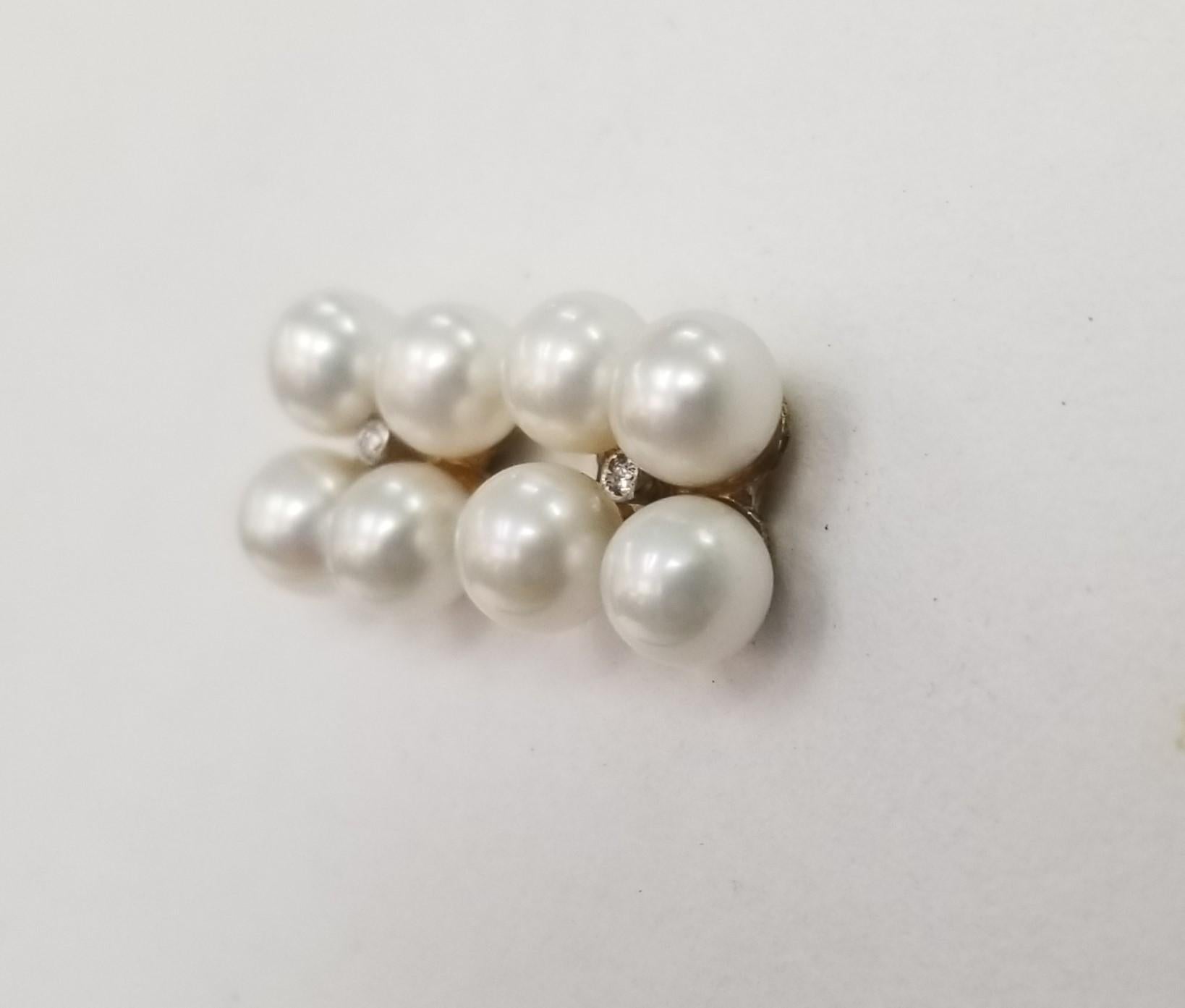 Vintage Pearl and  Diamond  Earrings in 14K Yellow Gold
Specifications:

Metal: 14K

Main Stone: 2 Diamonds.01 GH SI

Side stones: 8-5mm Pearls
 

