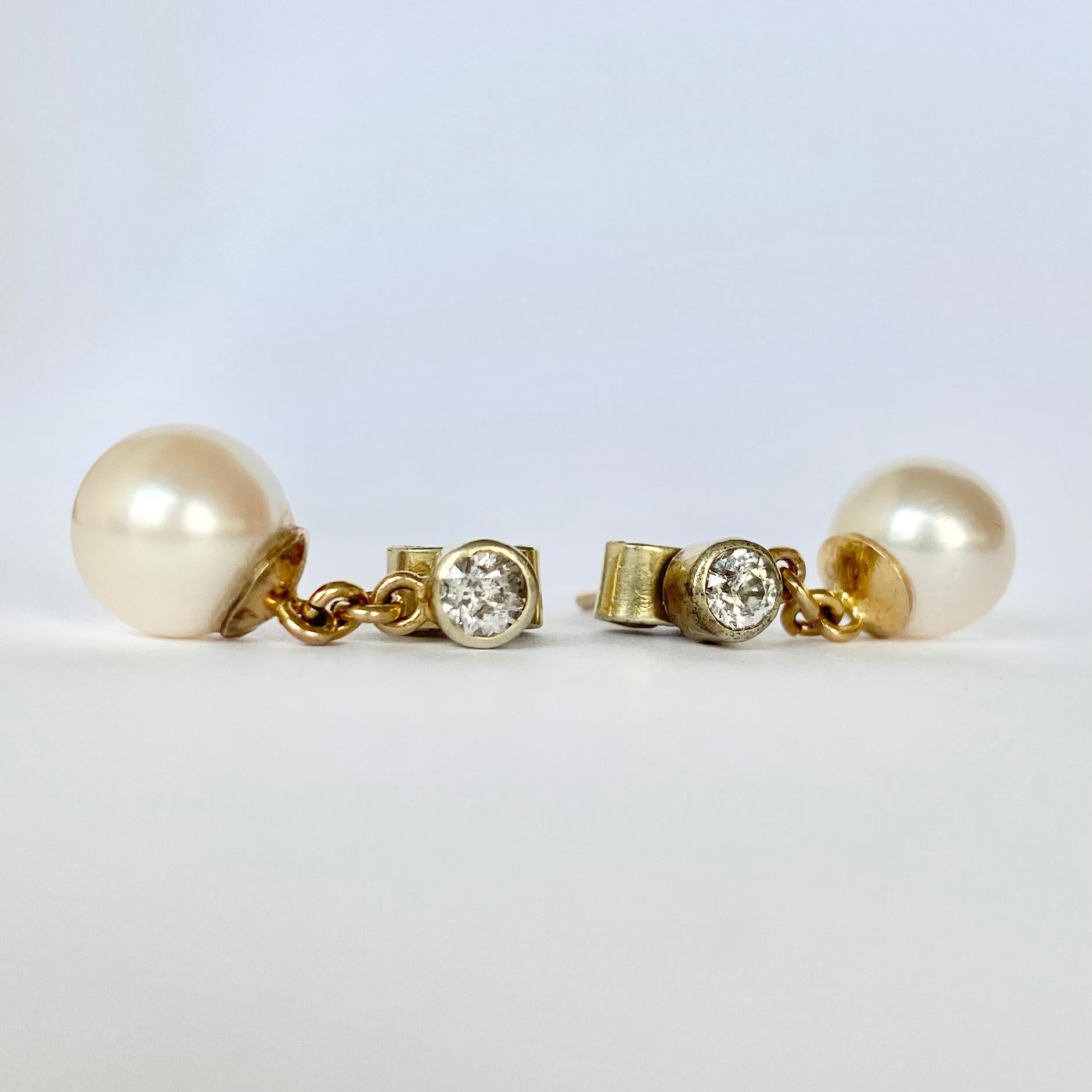 These gorgeous pearl drop earrings also hold diamonds to add a little sparkle! The pearls are bright and smooth and the diamonds measure 25pts per earring. These come in their original Burlington Arcade box. 

Drop from ear: 18mm

Weight: 3.4g