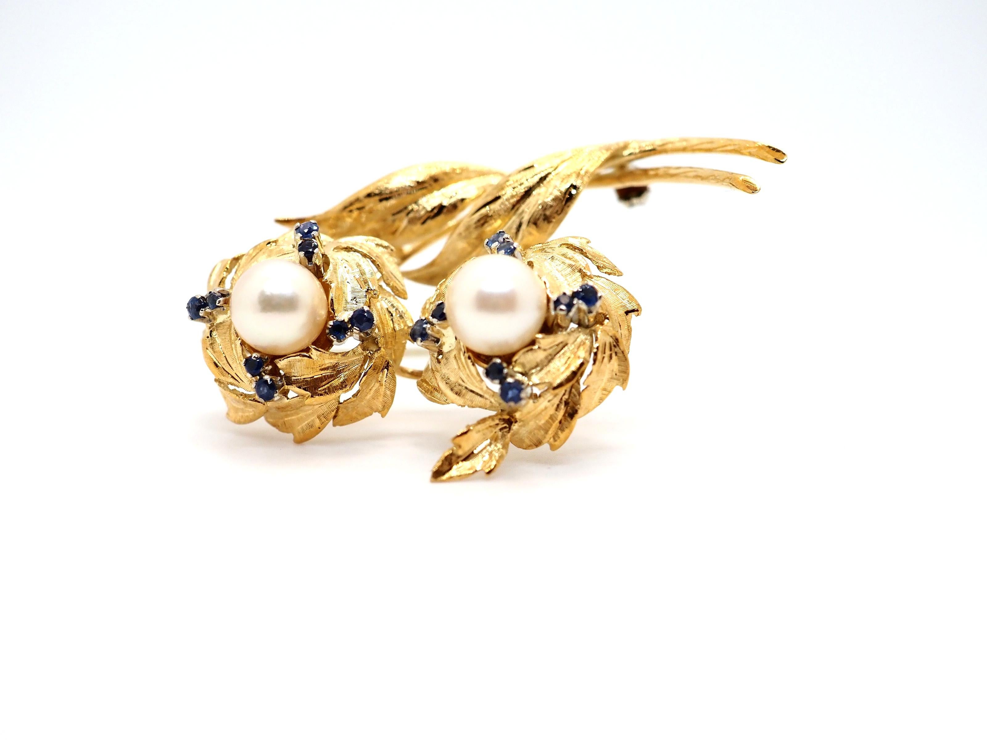 An elegant vintage brooch crafted in 18K yellow gold. It features 16 small sapphires and 2 pearls. The designs of this item was inspired by nature. And this theme was very popular during the 50s and 60s, when the brooch was created.

Total weight: