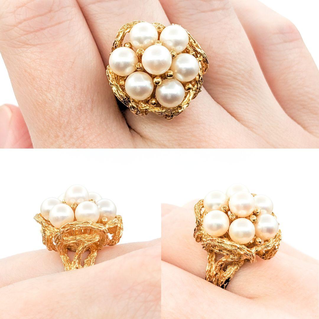 Vintage Pearl Cluster Cocktail Ring In Yellow Gold

This beautiful ring is crafted in 14k yellow gold and features 7 5.75mm Akoya Pearls. This piece also features intricate metal work to add dimension to the band of the ring. This piece is a size