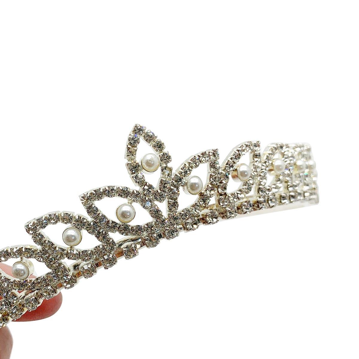 A vintage pearl marquise tiara. Enjoy the age-old tradition on your wedding day with this emblem that signifies the crowning of love.

Vintage Condition: Very good without damage or noteworthy wear.
Materials: silver plated metal, simulated pearls,