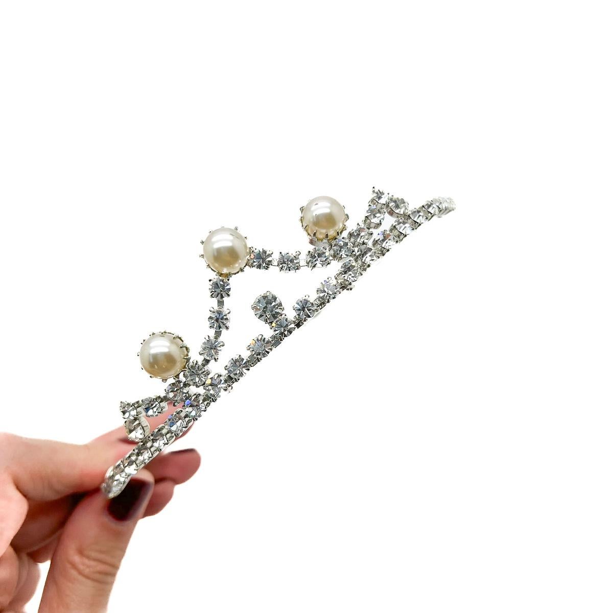 A Vintage Pearl Crystal Tiara. A trio of pearls adorn this coronet inspired tiara.
An unsigned beauty. Just because a jewel doesn’t carry a designer name, doesn’t mean it isn't coveted. The unsigned beauties in our collection are sourced