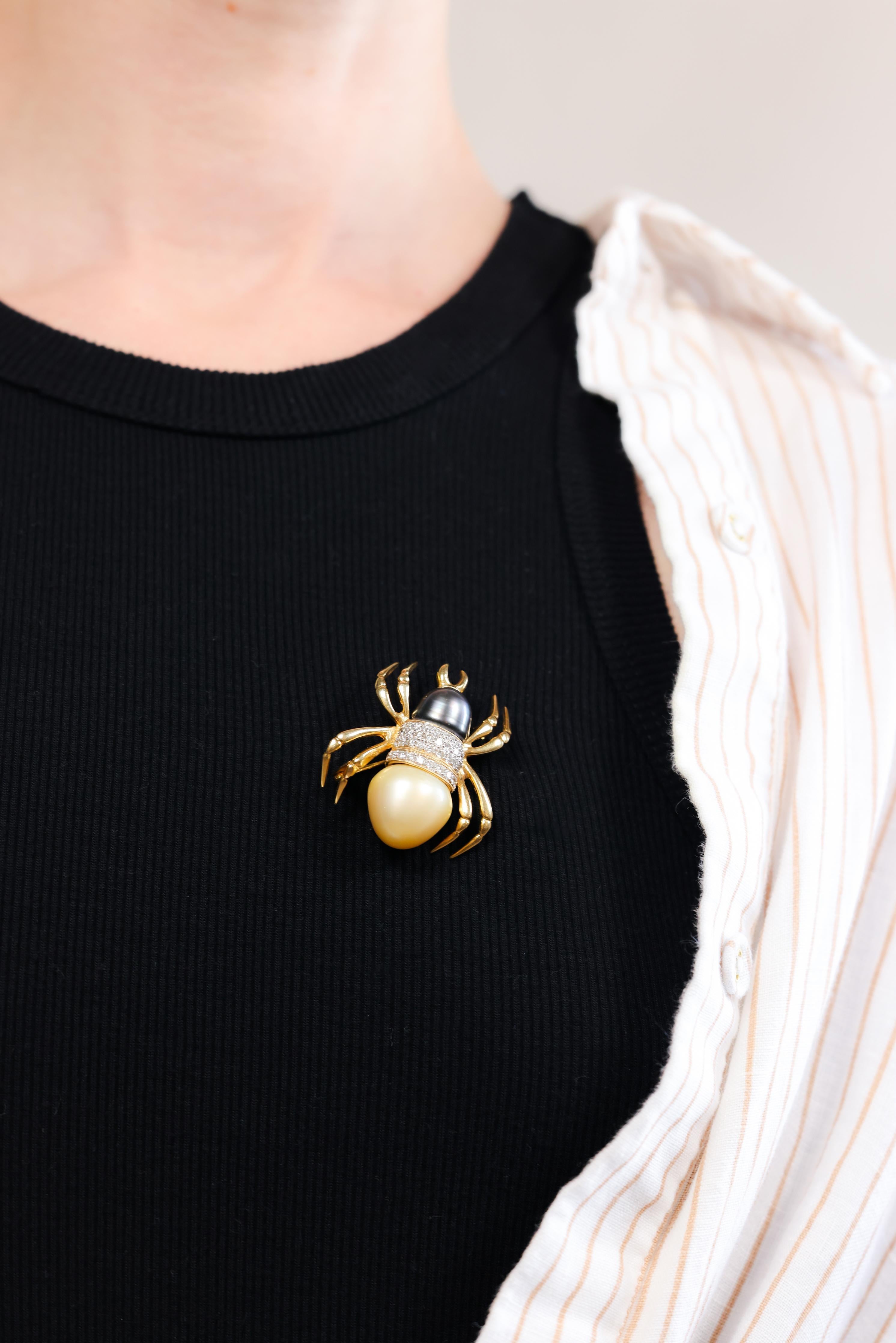 One Vintage Pearl Diamond 18k Yellow Gold Spider Brooch. Featuring one golden Tahitian pearl measuring approximately 17.00 millimeters and one Tahitian black pearl measuring approximately 12.60 millimeters. Accented by 40 round brilliant cut