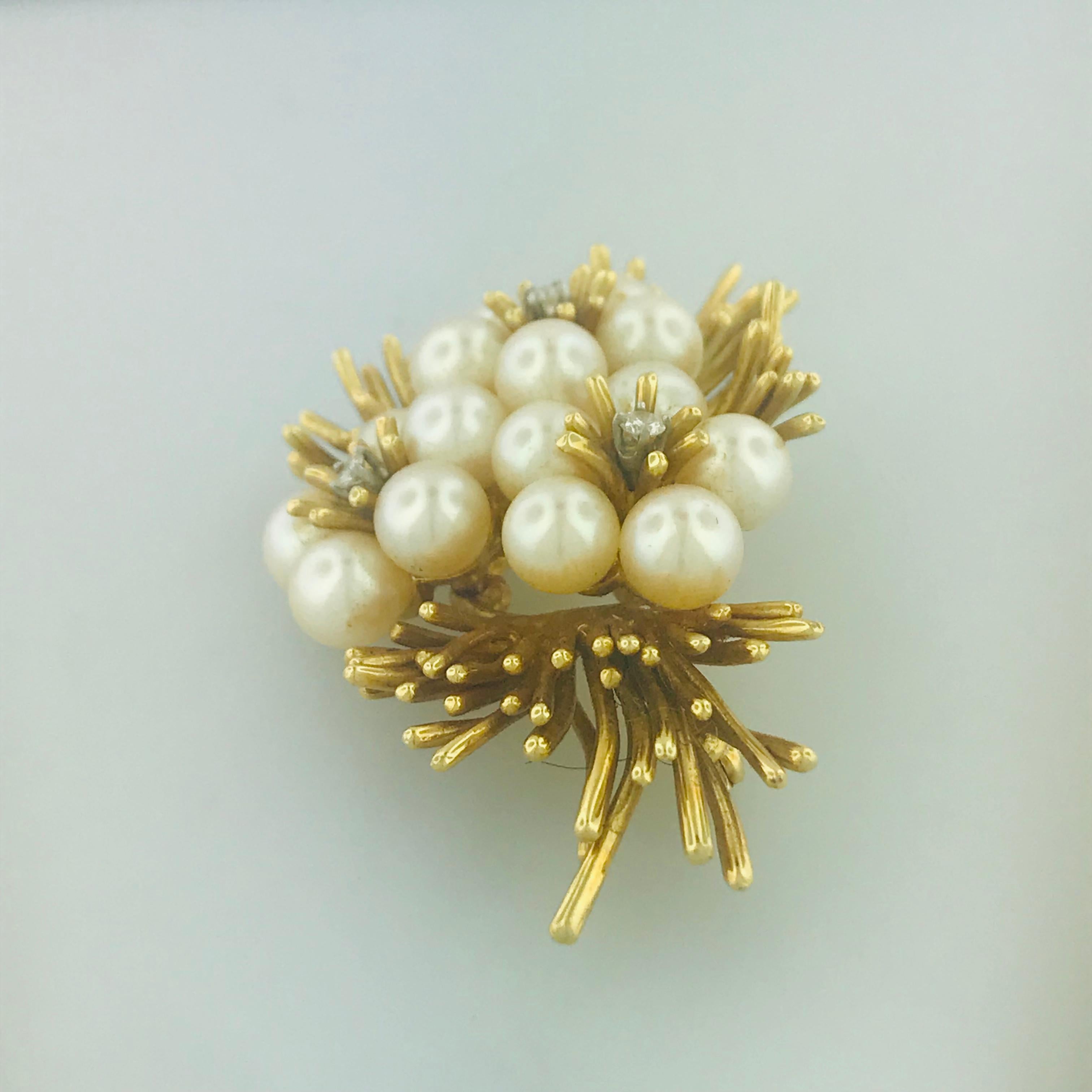 How fabulous is this vintage floral inspired brooch/pin? Made with three natural round brilliant diamonds and fifteen beautiful saltwater Akoya cultured pearls that have been adored and well taken care of. The rich 18 karat yellow gold compliments