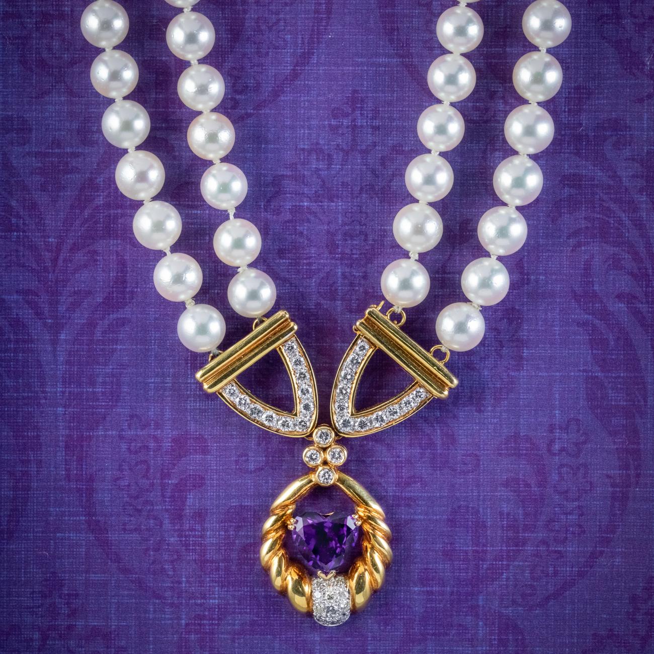 A beautiful vintage pearl lavaliere necklace from the mid 20th century featuring two strands of lustrous, white pearls leading to a fabulous 18ct gold dropper lined with pave set brilliant cut diamonds (approx. 1.60ct total) and an amethyst heart in