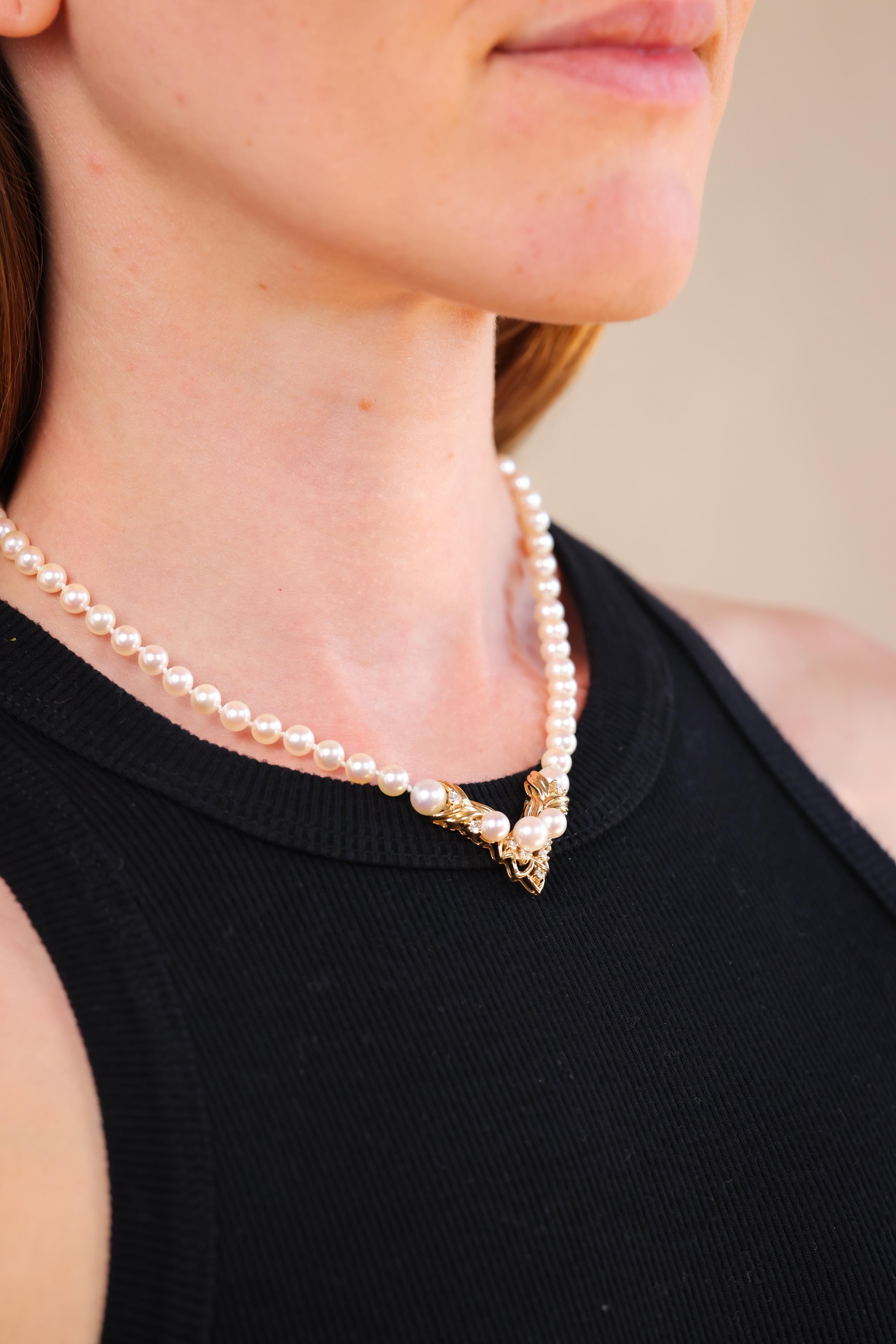 pearls stand ranges from 6.9mm to 5.5mm
9 round brilliant cut diamonds weighing approximately 0.30 carats 
I-J color 
I1
14k yellow gold with purity marks
circa 1960s 
16 inches long 
22.5 grams 


Immerse yourself in the classic charm of the 1960s