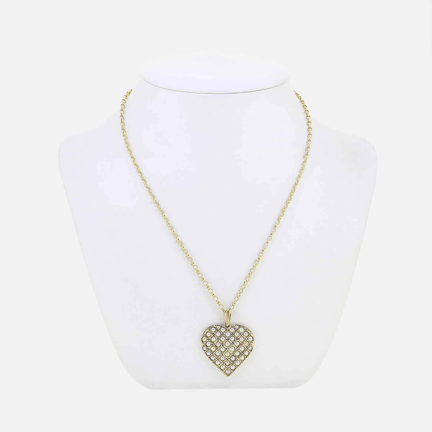 Here we have a gorgeous pearl pendant necklace. This vintage piece has been crafted from 9ct yellow gold with the pendant forming the shape of a love heart. This large motif plays host to a vast array of round shaped cultured pearls; each of which