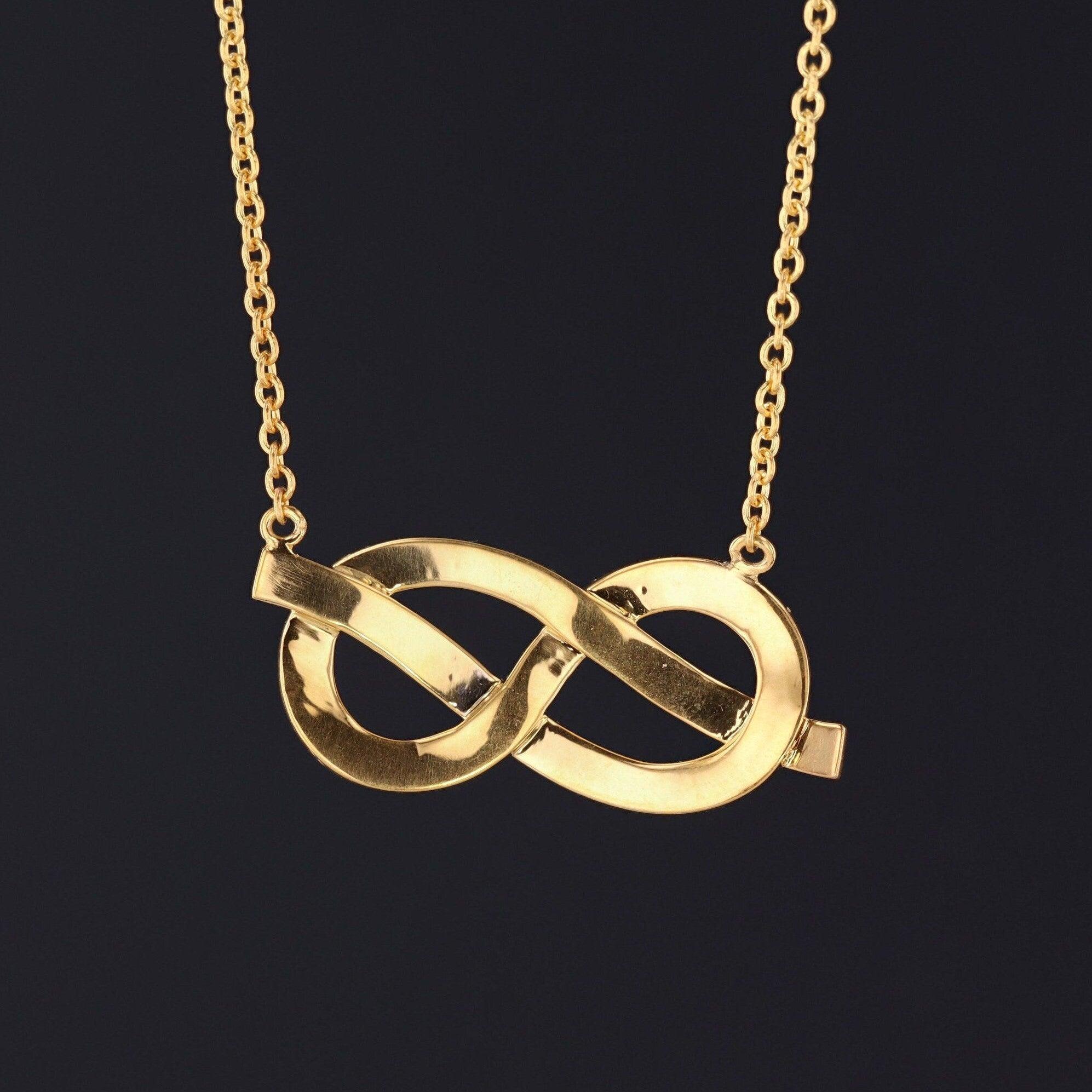 The infinity symbol represents a line that never ends and is the perfect way to express your love for someone. 

This beautiful love token necklace features an infinity knot accented with half pearls. The love knot was originally a vintage brooch