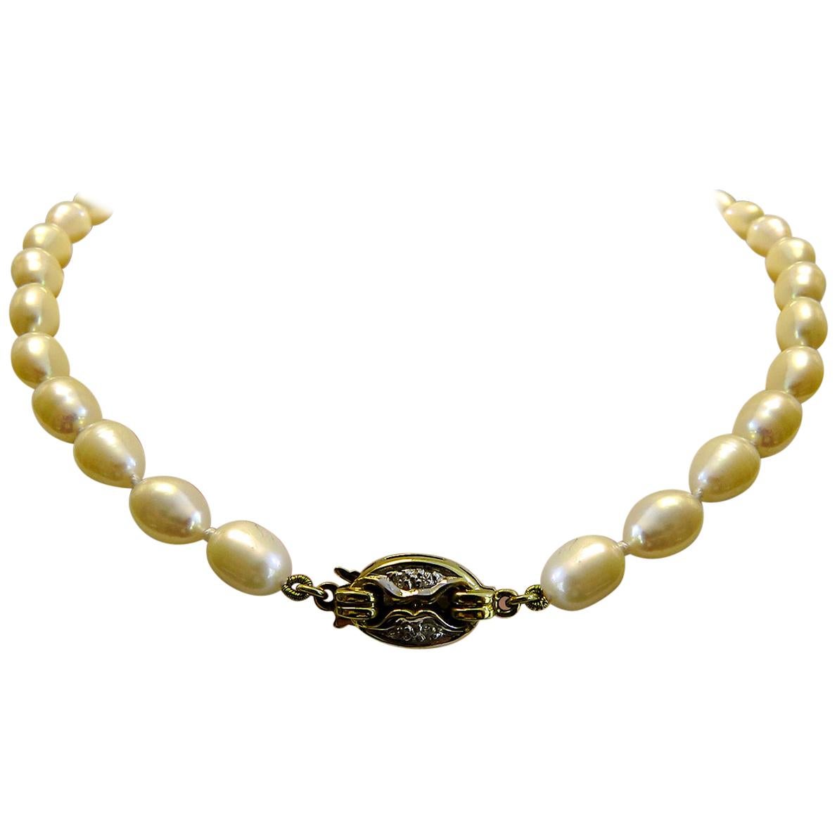 Vintage Pearl Necklace with 14 Karat Gold and Diamond Brooch For Sale