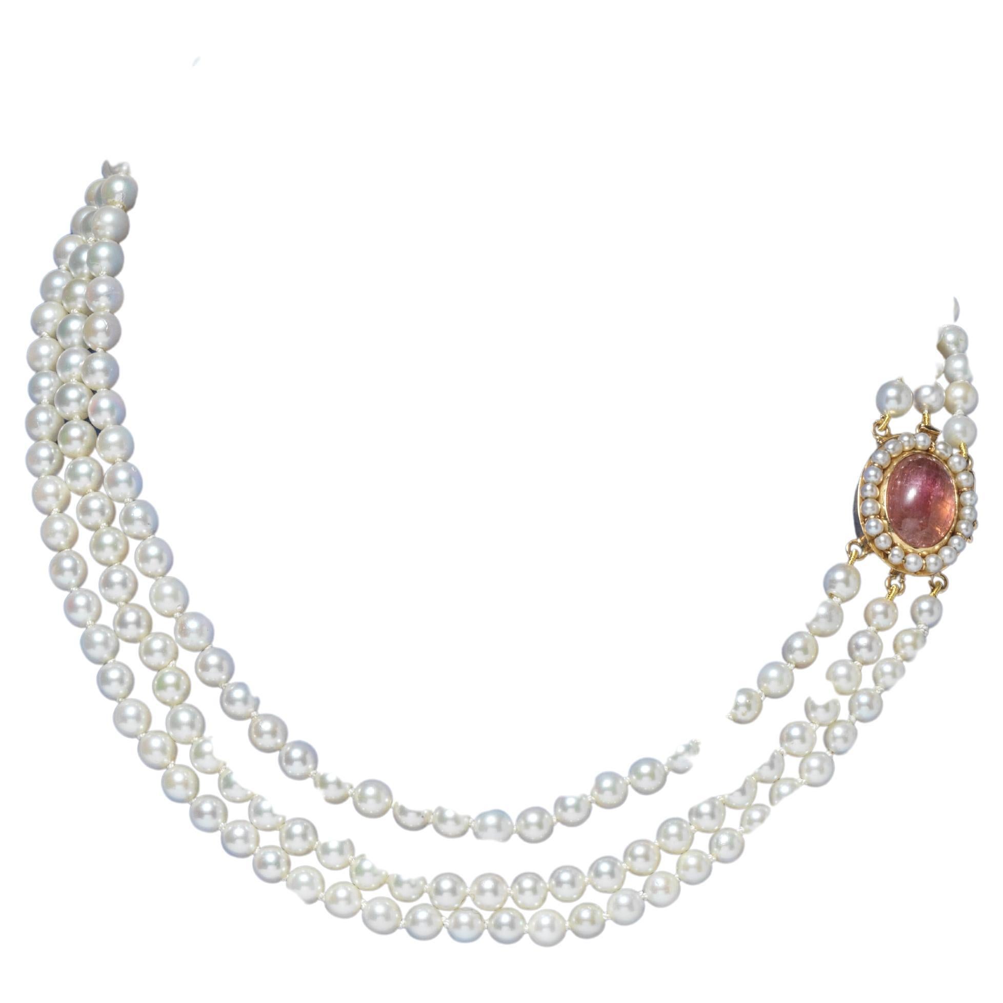 A charming pearl necklace with three rows of pearls that closes together with a 18 k gold lock that has a cabochon cut turmalin in the middle. The lock is made by the Swedish goldsmith K H Augustsson in 1963.

The design of the lock is charming and