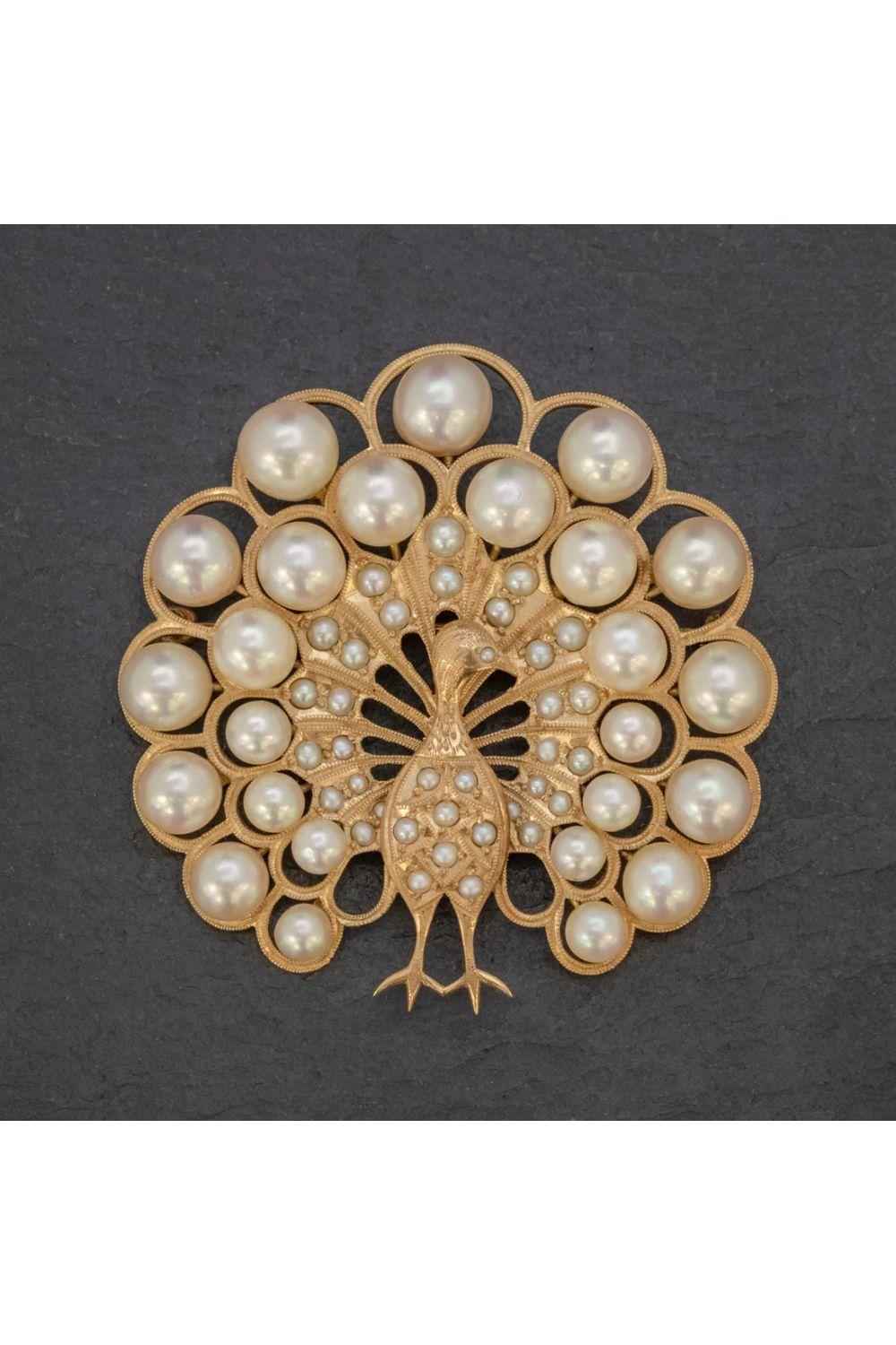 A majestic vintage peacock brooch decorated with an array of lustrous cultured pearls of various sizes that graduate out from the body and across the peacock’s large and extravagant tail feathers.

The piece is a wonderful open-worked design, with