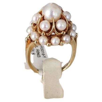 Don't wait to get your hands on this one of kind vintage pearl ring! Set in 14K Yellow Gold, this ring holds 19 white round pearls all in different sizes. The ring is currently at a size 6 but can be resized to fit.