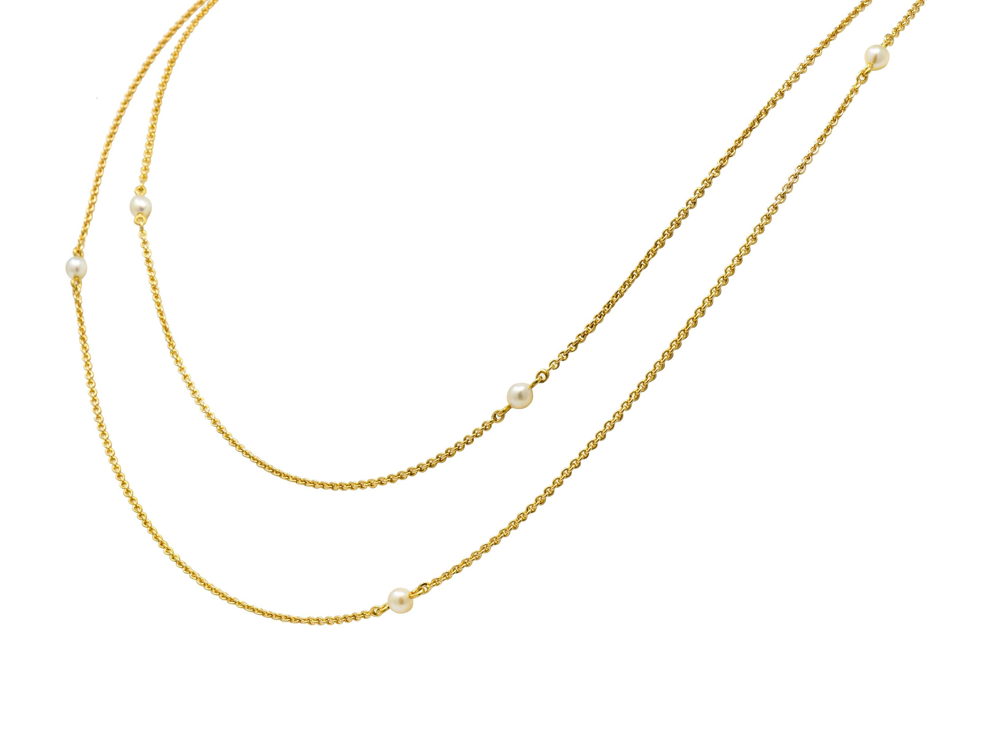 Long chain necklace comprised of 14 karat gold cable chain and ten pearl stations throughout

Pearls measure approximately 4.0 mm, cream in body color with moderate rosé overtones and excellent luster; very well-matched

Completed by a 10 karat gold