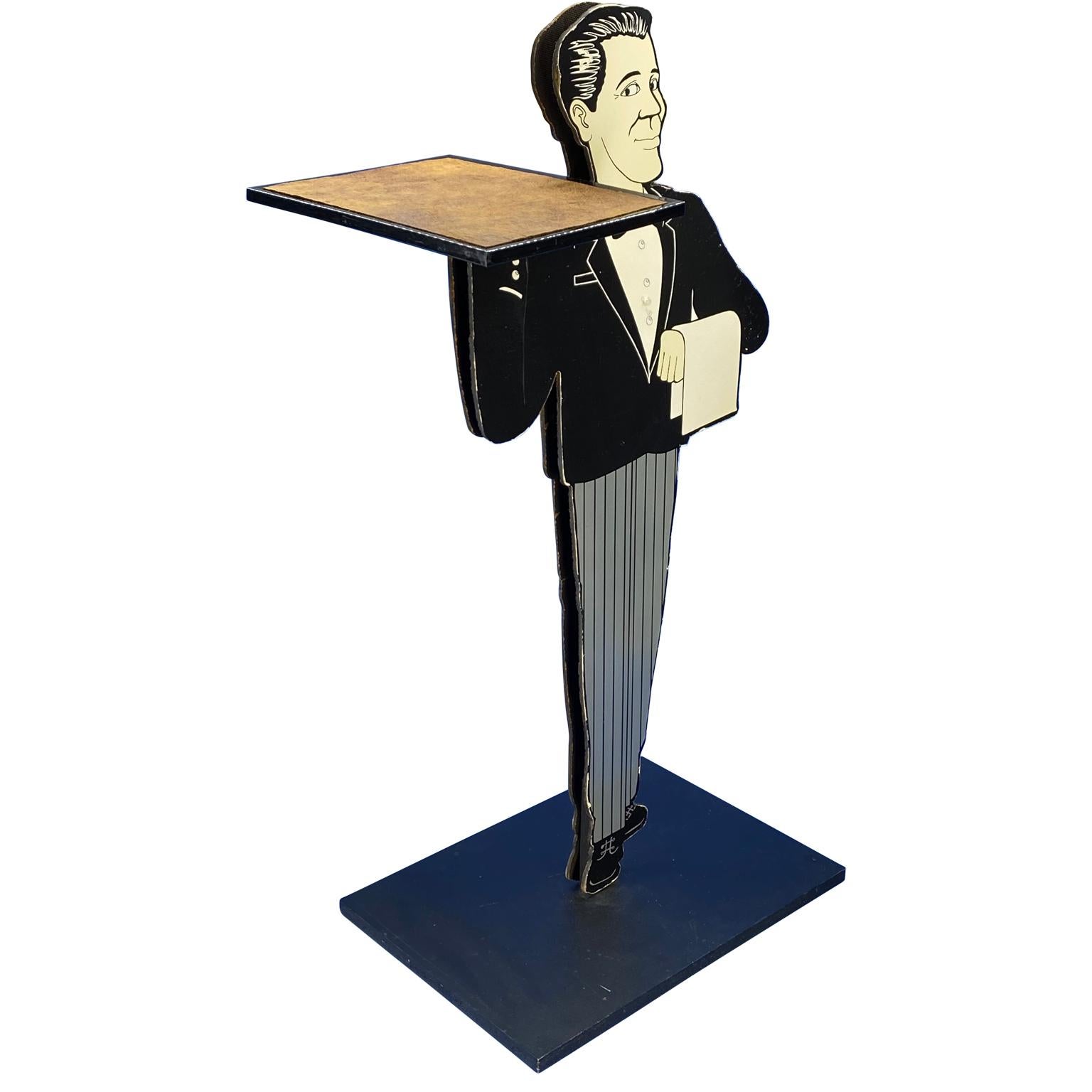 Vintage pedestal for a entrance area or hall in the shape of a waiter with butterfly.
The dumbwaiter holds a tray with leather covered top. The butlers tray can for used for keys, business cards or restaurant menus.
  