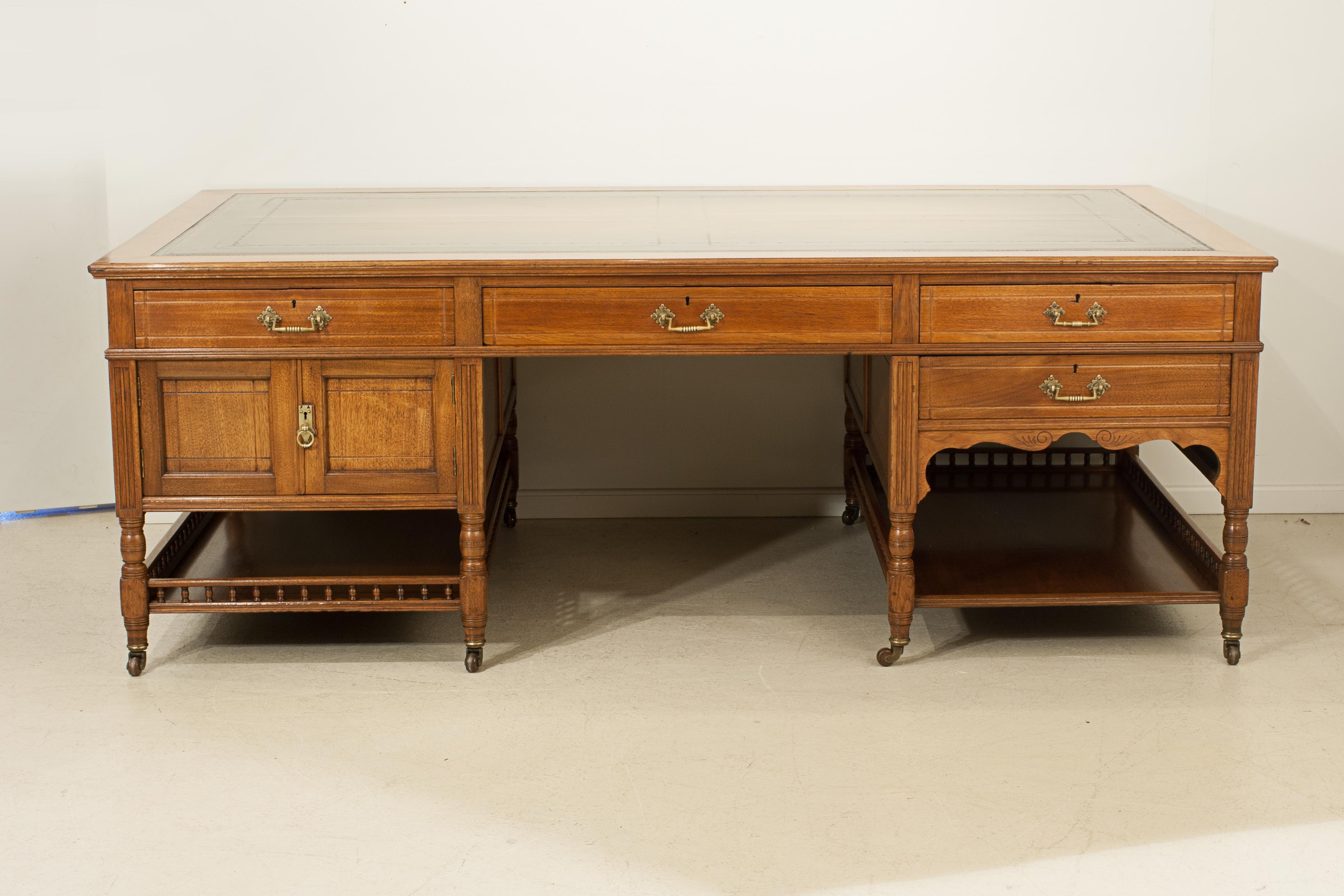 Aesthetic Movement Partners Desk.
A large late 19th century walnut pedestal partner's desk. The Victorian rectangular desk with a tooled green leather writing surface, each pedestal fitted with one drawer to the front and a cupboard to the rear.