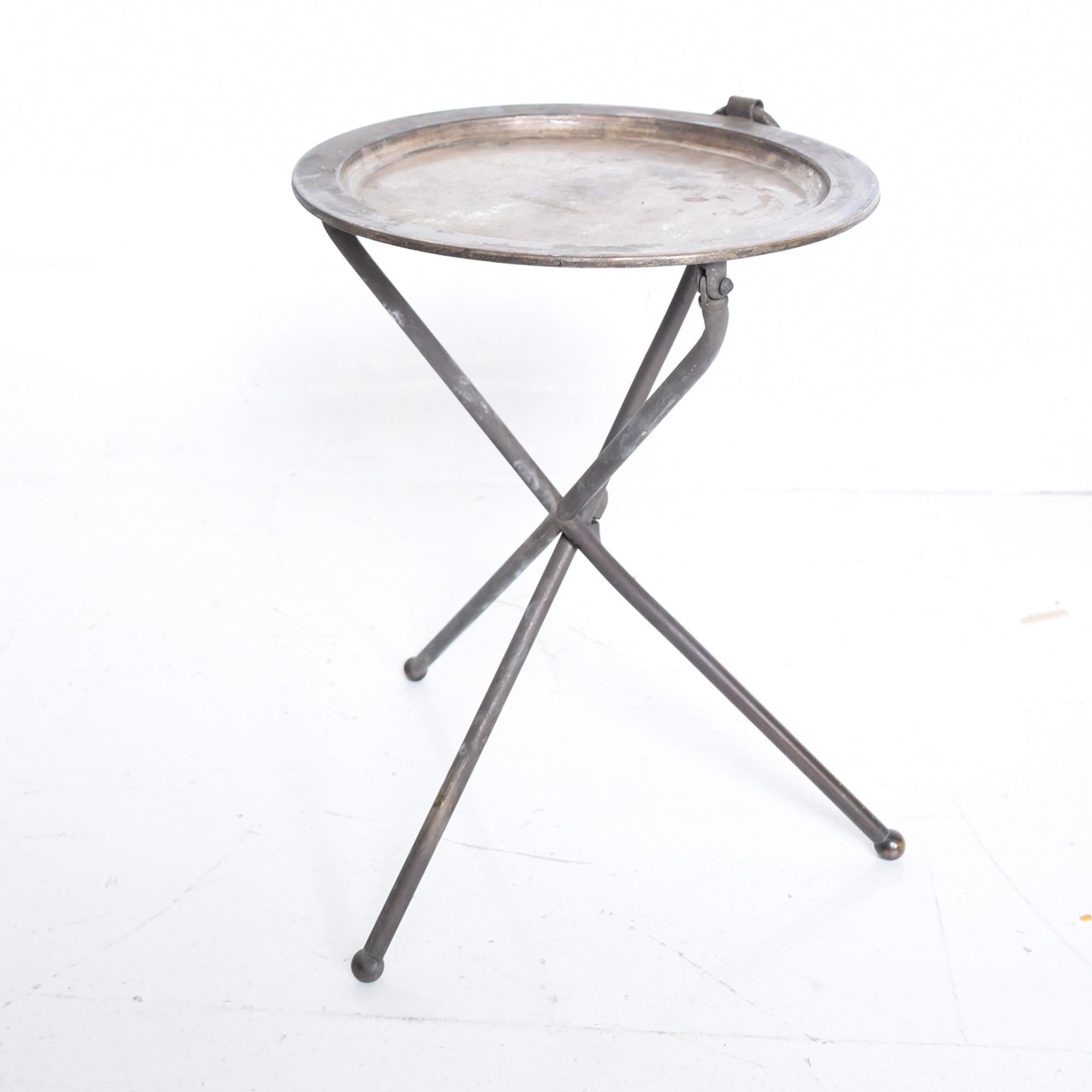 Vintage Pedro Domecq folding service tray table tripod base in silver plated brass. 
Mexico, circa 1980s.
Dimensions: 16.5 x 15 in diameter, 12.25 diameter top.
The table can be folded flat- has a ring so it can be hung.
Original vintage