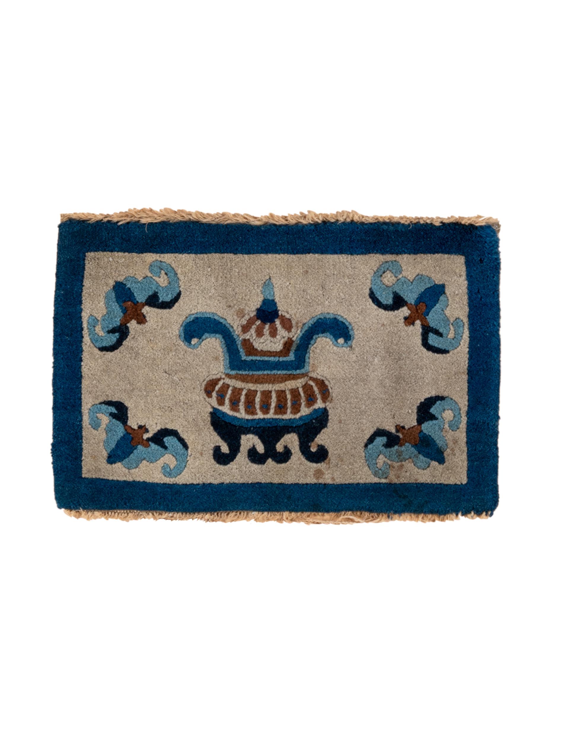 This charming ruglet displays a light pearl field centred by a tri-legged censer in red and shades of blue. Four blue-toned bats flutter about in the corners. Dark blue plain border.  Cotton foundation. Good condition. Makes an excellent