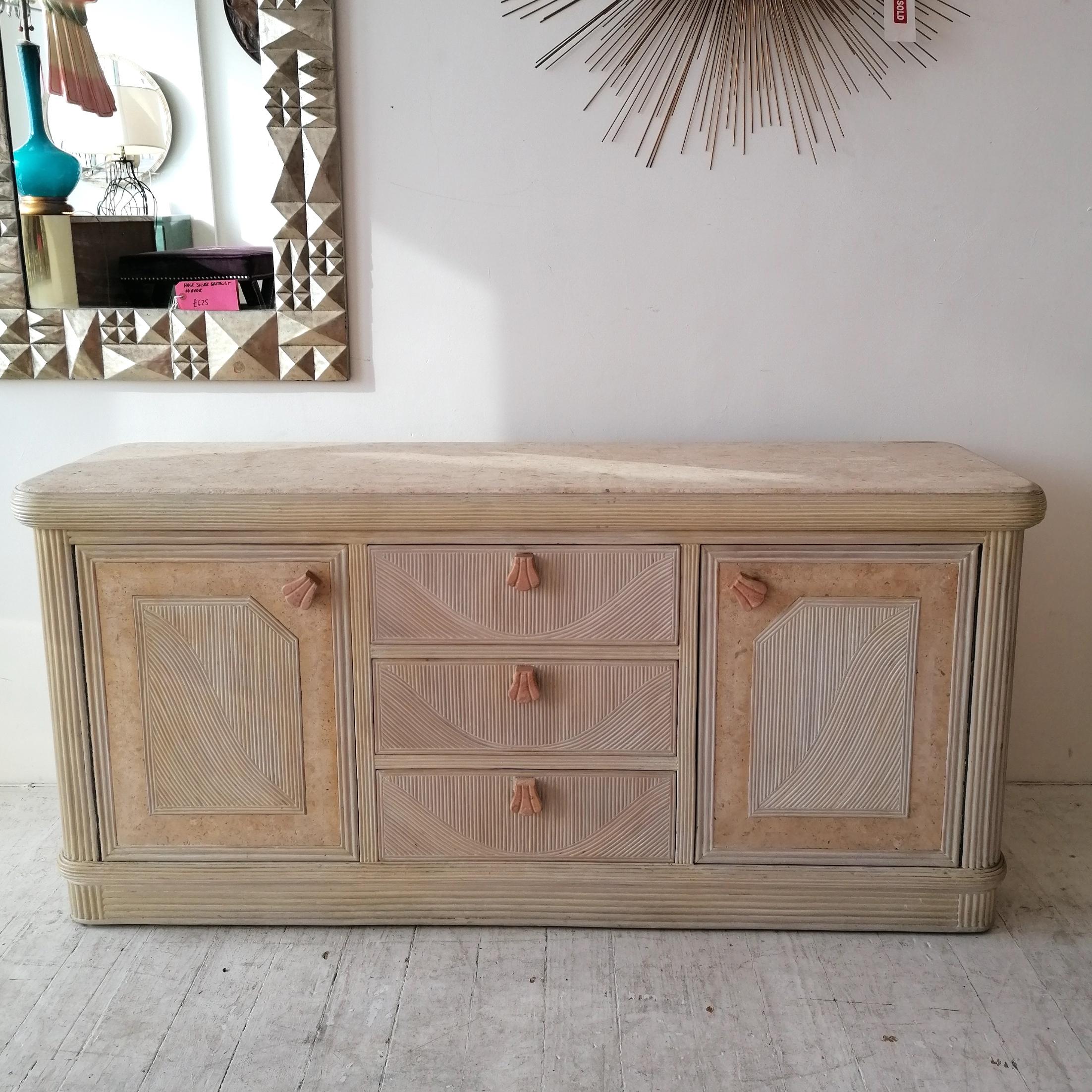 Vintage American pencil reed sideboard with pink scalloped marble handles & mactan stone top. Three central doors flanked by shelved storage cabinets.

Dimensions : width 167cm, depth 48cm, height 78.5cm.