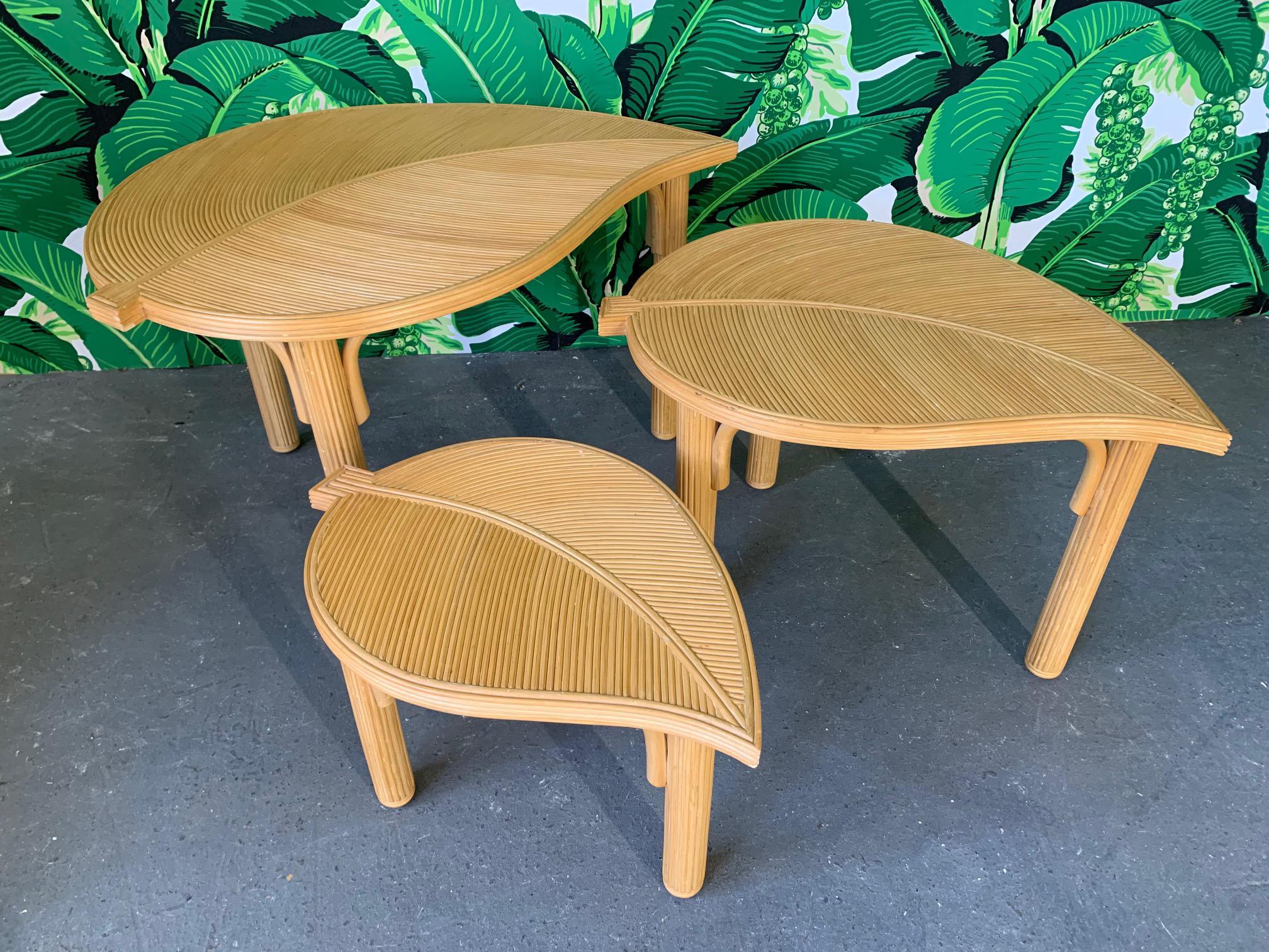 Set of 3 rattan nesting tables feature pencil reed inlay and sculptural leaf forms. Very good condition with minor imperfections consistent with age.
Measurements:
Table 1: 34