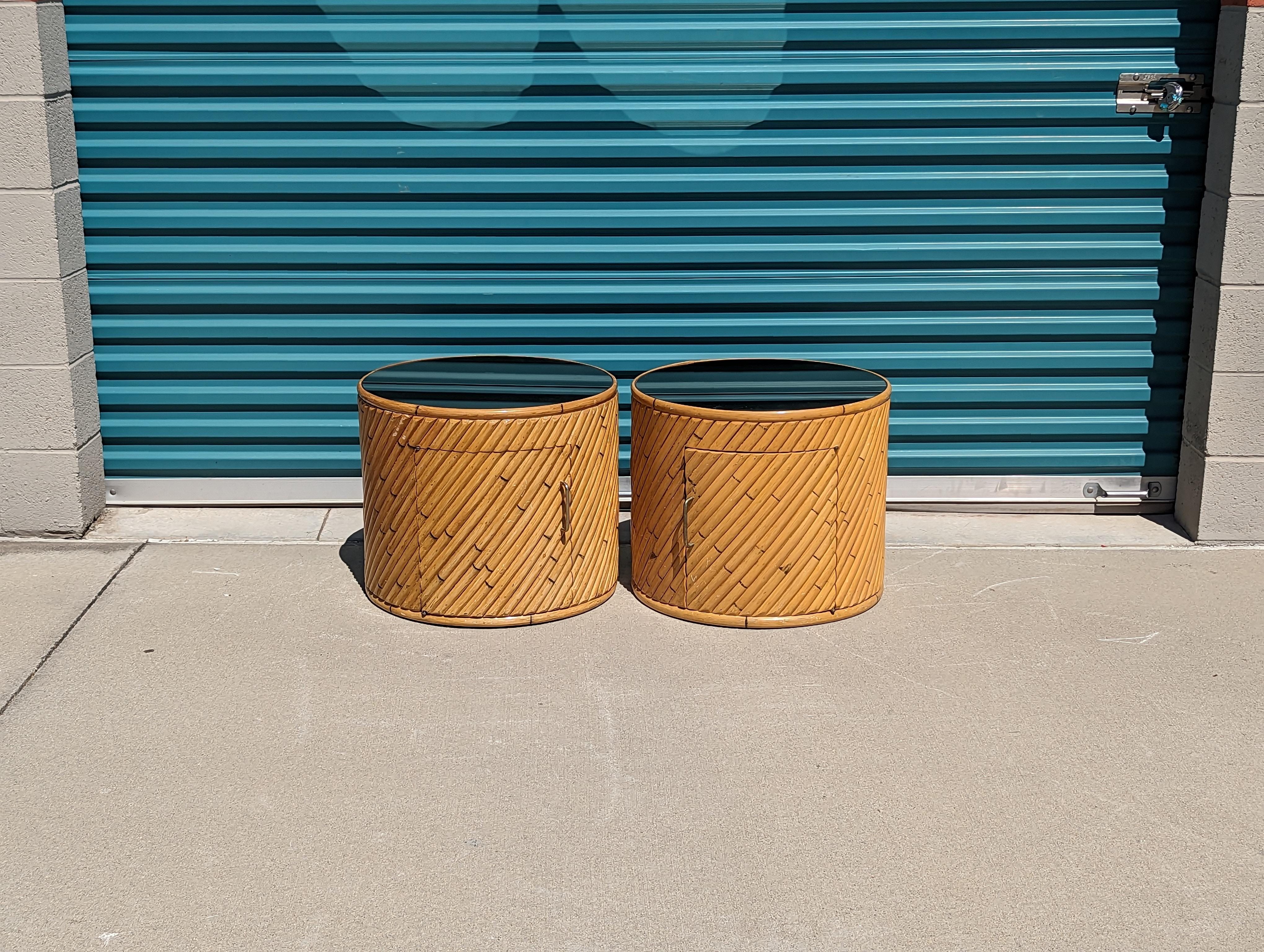 Sourced from the California Desert of Palm Springs, for your consideration is a pair of lovely pencil reed side tables with mirrored tops, c1980s. They both feature smoked mirrored tops, perfect for a nice contrast in any setting. 1 door on each