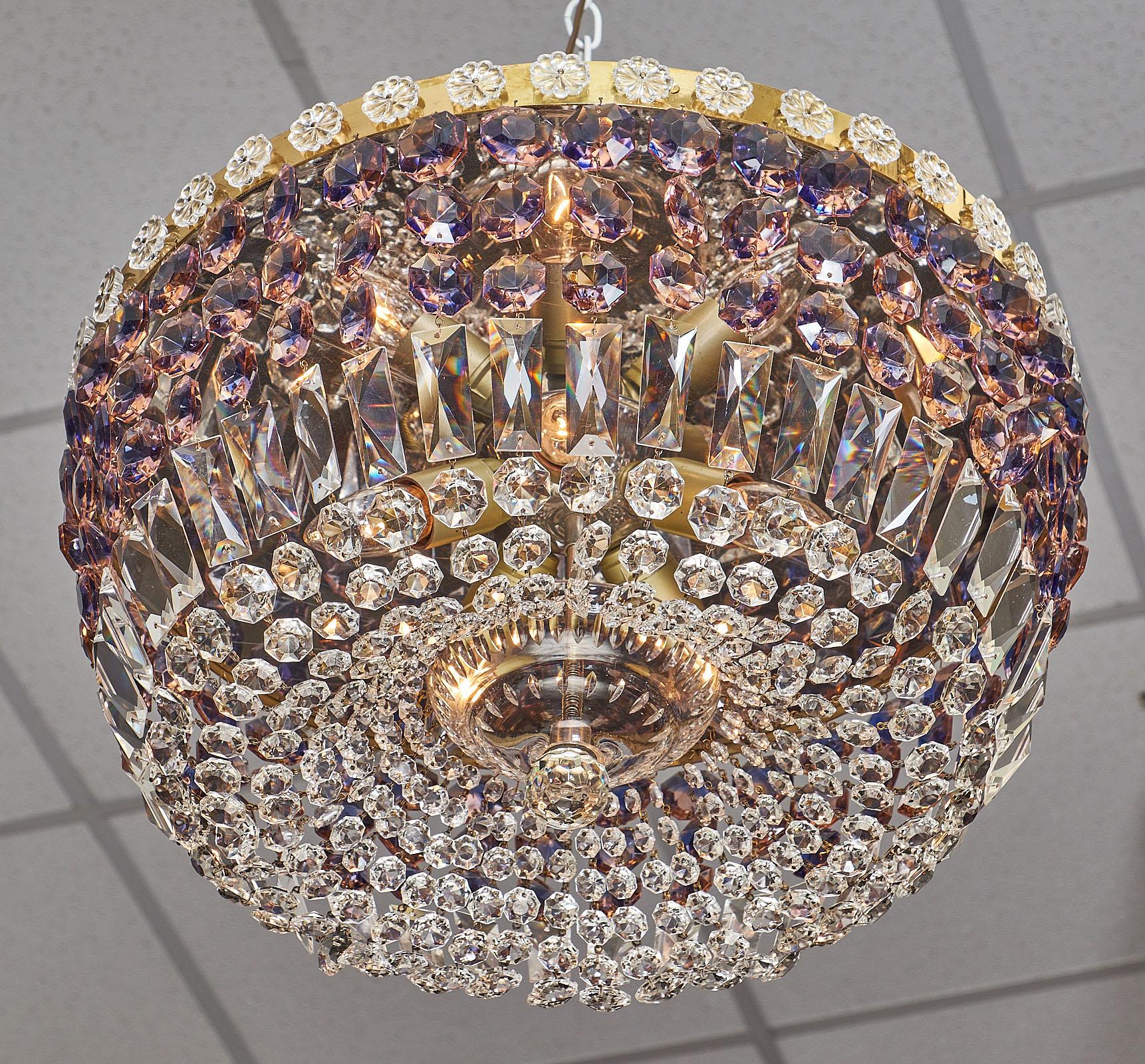 A spectacular French crystal vintage pendant chandelier. This beautiful piece has a brass structure with lovely clear and amethyst cut crystal strands. A crystal finial completes the piece. It has been newly wired to fit US standards.