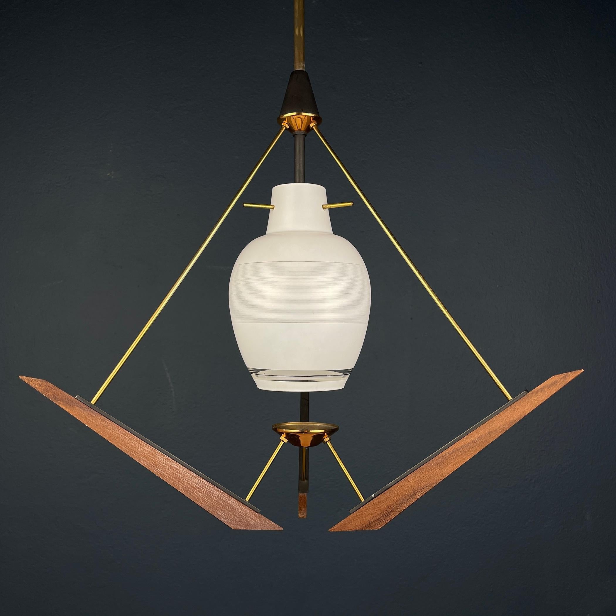 Illuminate your space with the charm of mid-century Italian design through this exquisite Vintage Pendant Lamp crafted by Stilnovo in Italy during the 1970s. This piece represents the epitome of mid-century Italian lighting, showcasing a harmonious