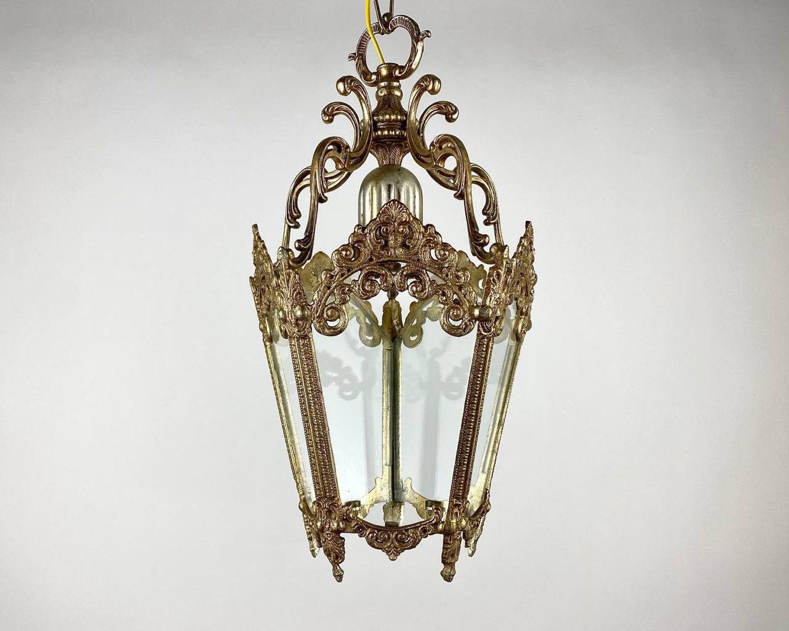 Vintage 5 sided Iron and Glass Ceiling Lantern. 

Very beautiful decorative iron lantern chandelier with five glass panels and forged metal acanthus leaves. The gold paint on the acanthus leaves and all the decorative details looks delightful.