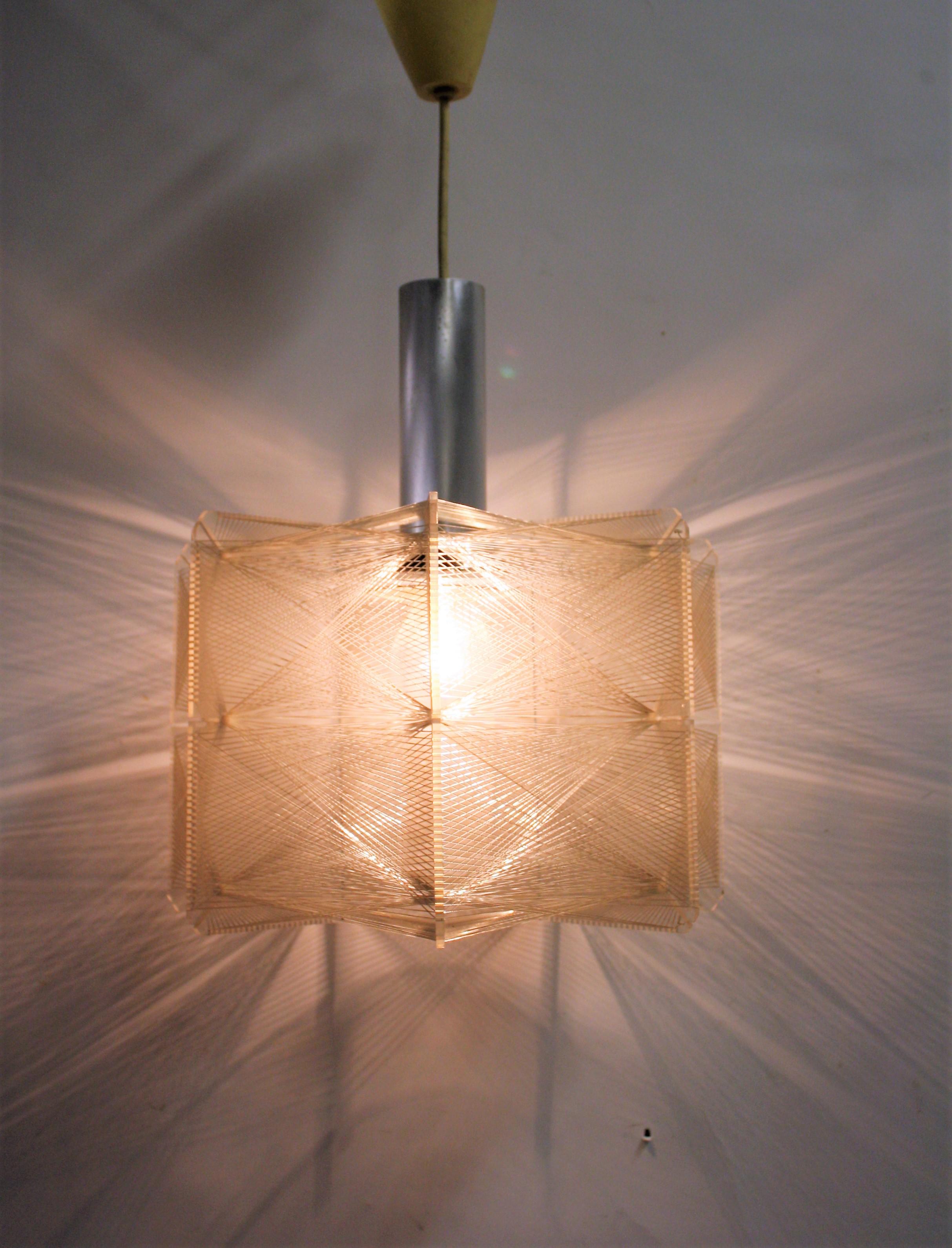 Midcentury chandelier designed by Paul Secon for Sompex.

The light is made of an acrylic/Lucite frame with nylon wires woven all around the chandelier to create a most loving light effect.

Very good condition, no missing wires.

The light is