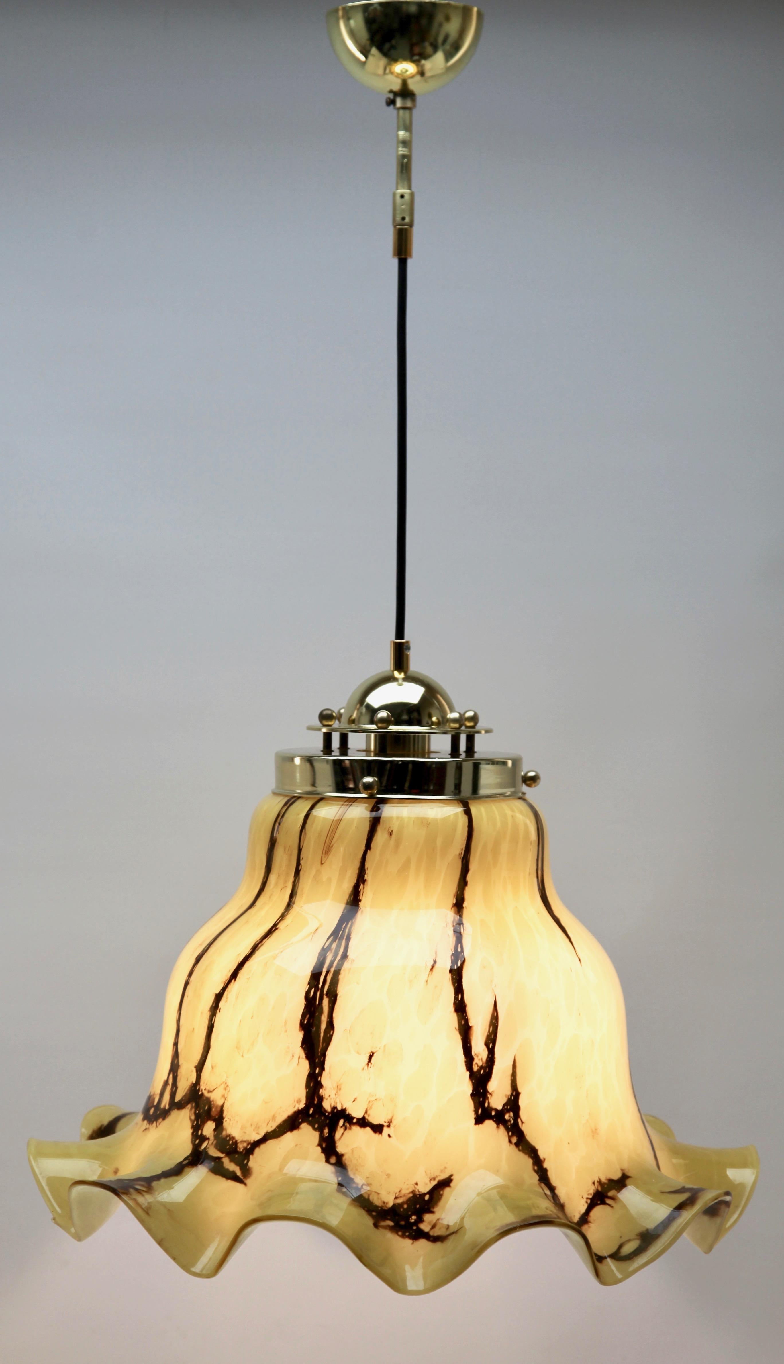 Vintage pendant light by Peill & Putzler, Germany. This central pendant light is crafted from heavy hand-blown glass with dramatic swirling clouds of brown and cream creating a cloudy feel. 

Photography fails to capture the simple elegant